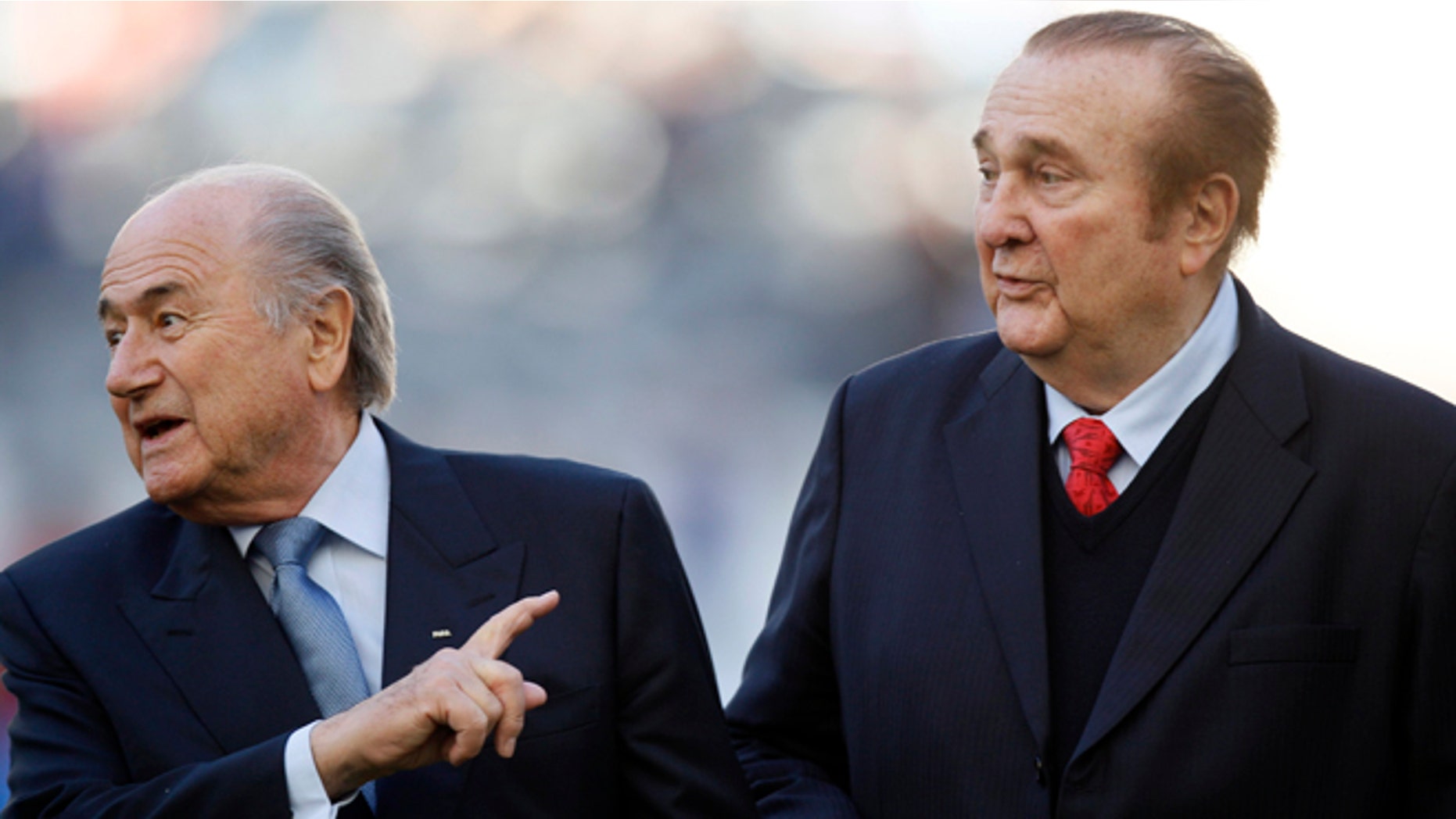FILE - In this July 23, 2011 file photo, FIFA President Sepp Blatter, left, and CONMEBOL President Nicolás Leoz, right, stand on the pitch before the start of the Copa America third-place soccer match between Venezuela and Peru in La Plata, Argentina. Loez's lawyer said Thursday, July 23, 2015, that U.S. prosecutors in New York have asked Paraguay to extradite the former president of South America's soccer confederation and one of those charged in a corruption scandal being investigated by the U.S. Justice Department. (AP Photo/Fernando Llano, File)