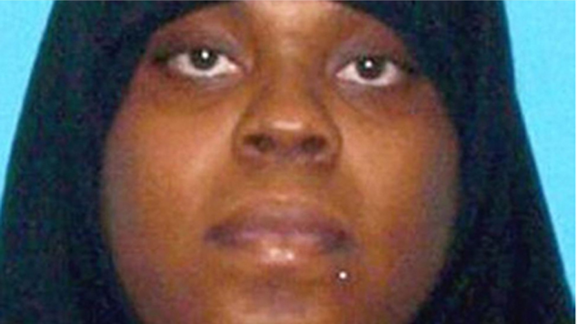 Latia Harris allegedly attacked a woman who was only protected by her 2-year-old son as bystanders did nothing.