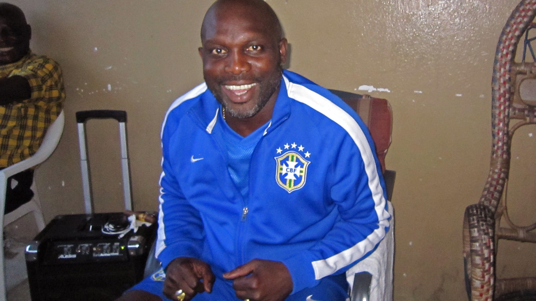 In this photo taken on Sunday, Aug. 10, 2014, Liberian soccer star George Weah smiles inside a room in the city of Monrovia, Liberia. Liberias world famous soccer star George Weah has produced a song to raise awareness about Ebola, the deadly disease ravaging West Africa. Weah, who before he retired was FIFAs player of the year, is now a politician and singer.(AP Photo/Jonathan Paye-Layleh)