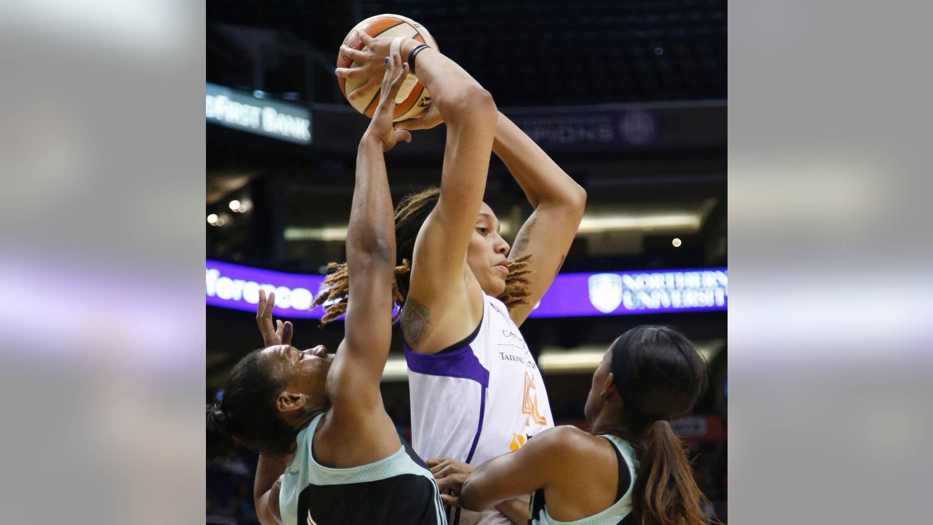 Phoenix Mercury's Brittney Griner looks to pass while being double-teamed by New York Liberty's Avery Warley, left, and Swin Cash during the first quarter of a WNBA basketball game Saturday, July 26, 2014, in Phoenix. (AP Photo/The Arizona Republic, Cheryl Evans)