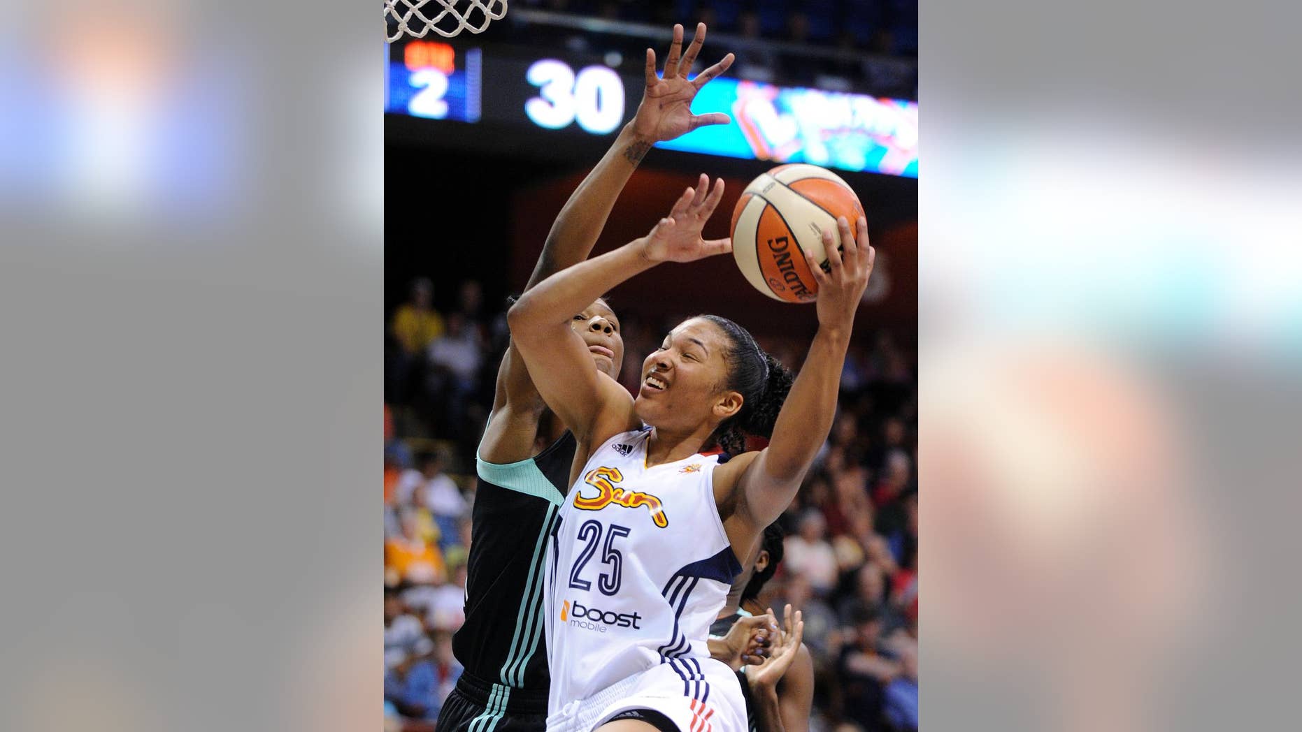 Connecticut Sun's Alyssa Thomas (25) drives past New York Liberty's Avery Warley during the first half of a WNBA basketball game in Uncasville, Conn., Sunday, June 15, 2014. (AP Photo/Fred Beckham)