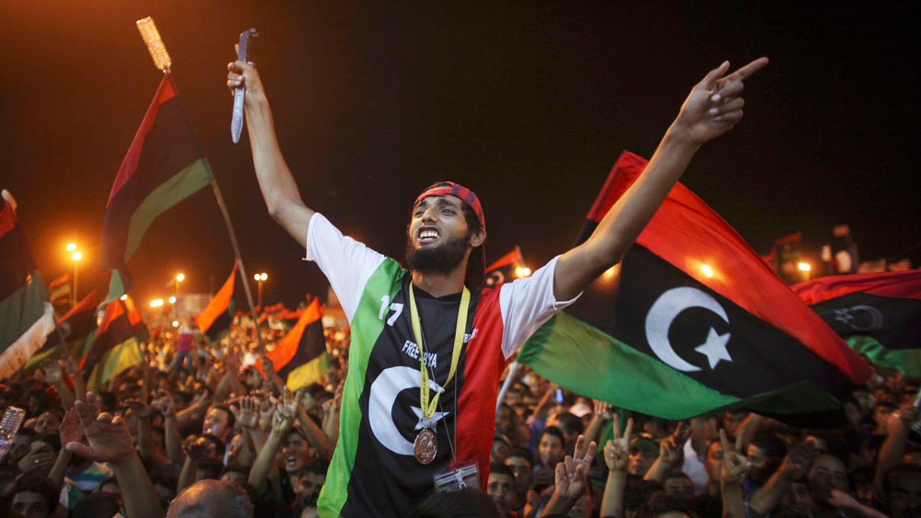 Aug. 22: People celebrate the capture in Tripoli of Qaddafi''s son and one-time heir apparent, Seif al-Islam, at the rebel-held town of Benghazi, Libya.