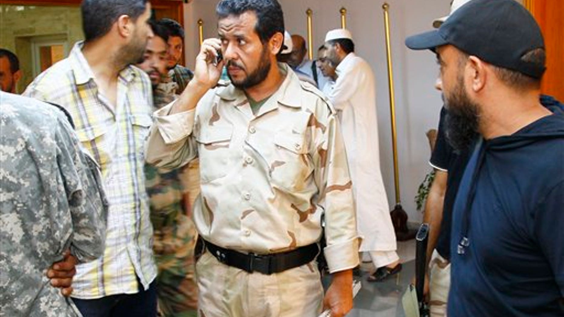 August 31: Libyan rebels' Tripoli military commander Abdel Hakim Belhaj, center, after an interview with the Associated Press in Tripoli, Libya.