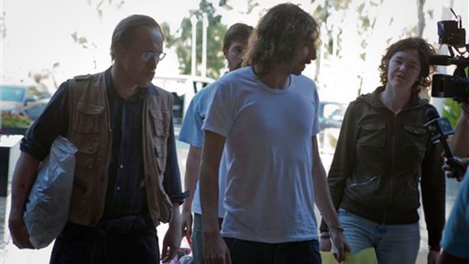 May 18: Freed American freelance journalist Clare Morgana Gillis, Spanish photographer Manu Brabo and British Nigel Chandler arrive at a hotel where most of the international media stays in Tripoli, Libya.
