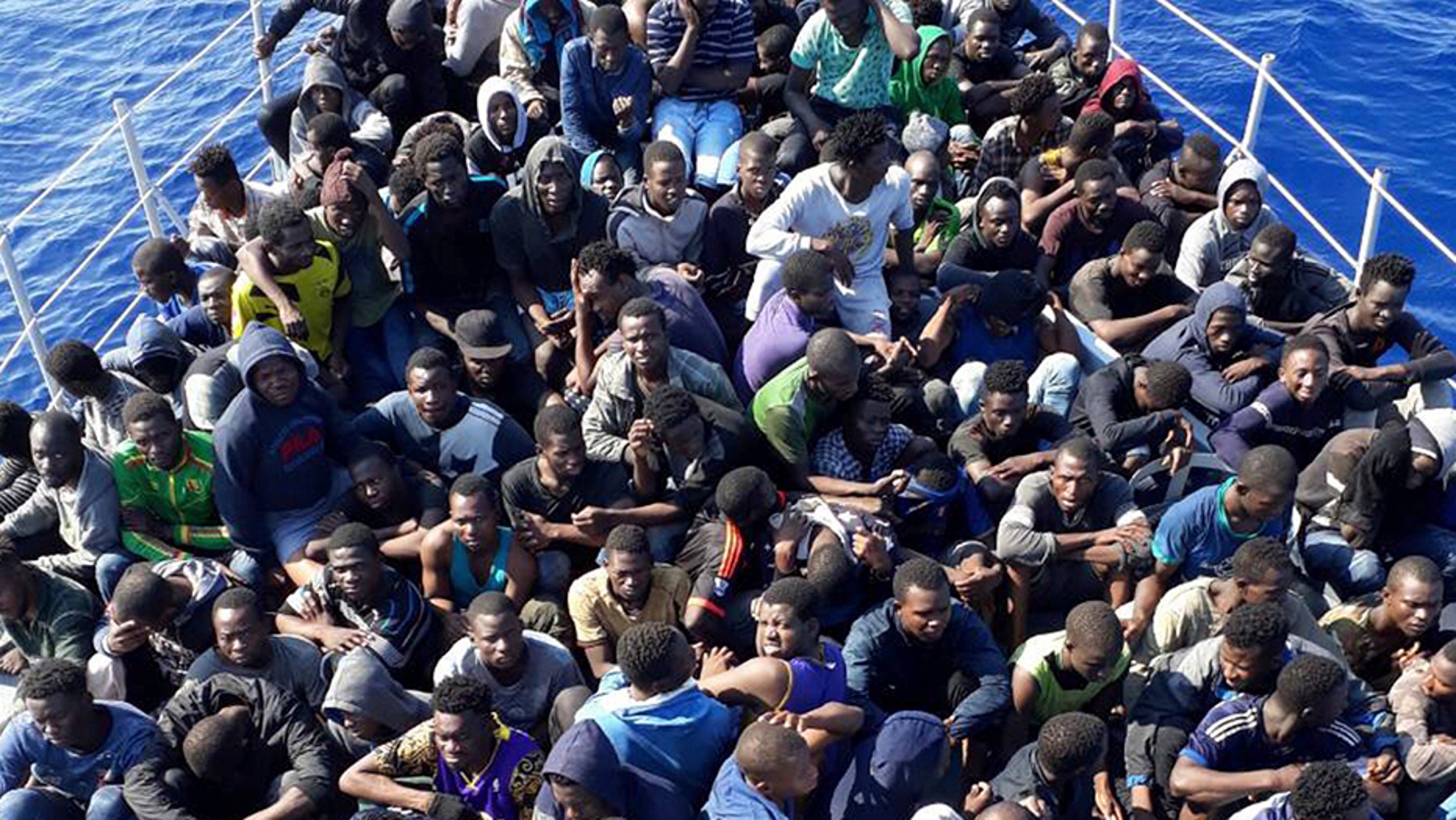 In this Sunday, June 24, 2018 photo, released by the Libyan coast guard, African migrants who were on boats in distress in the Mediterranean on their way to Europe, and rescued by the Libyan coast guard arrive to shore, east of the capital, Tripoli, Libya. Four boats, boarding 490 African migrants including 75 women and 21 children, were intercepted on Sunday off the town of Gohneima. (Libyan Coast Guard via AP)