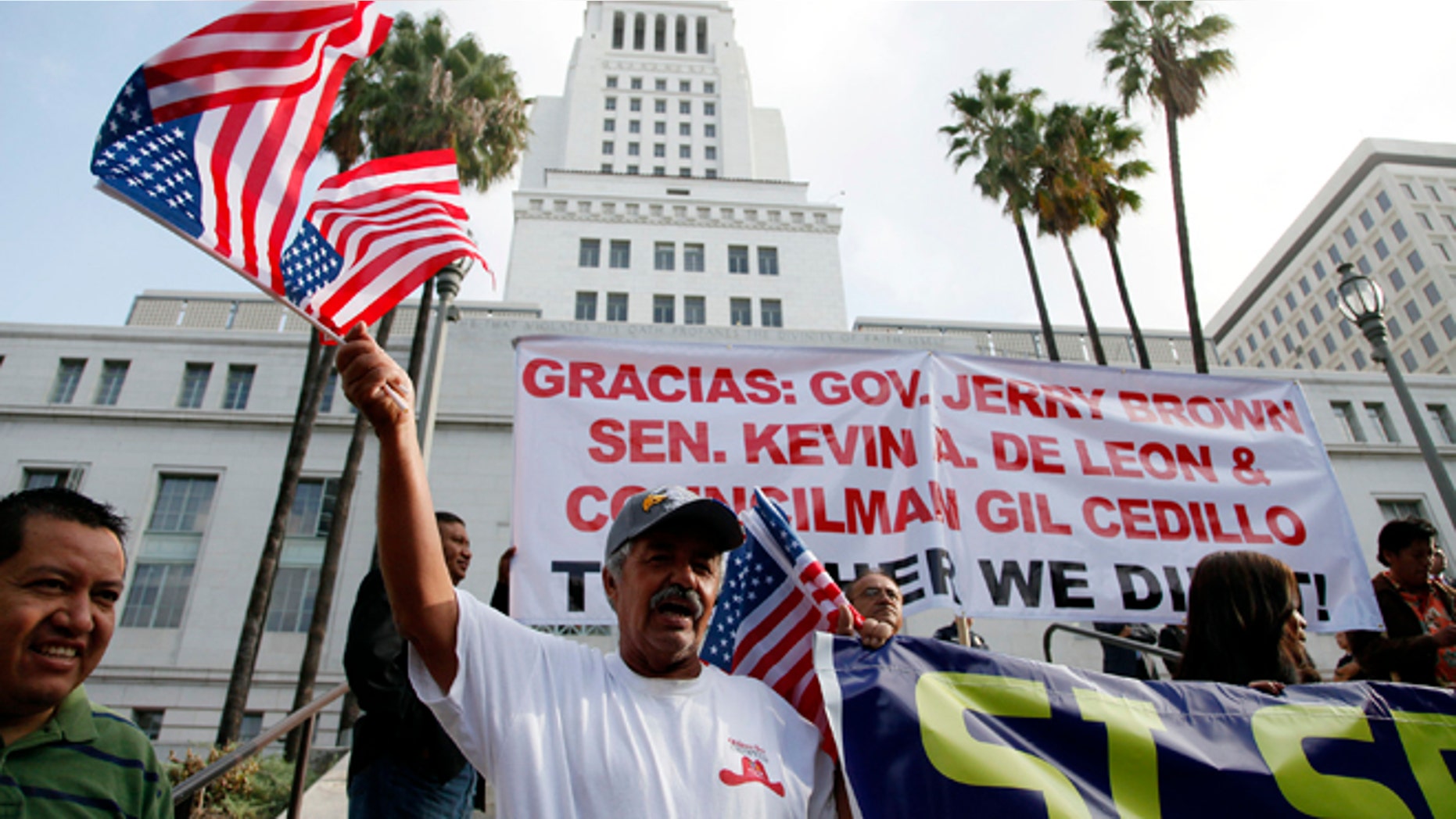 Oct. 3, 2013: Ipolito Nurez celebrates outside City Hall after California Gov. Jerry Brown signed the bill AB 60, which allows immigrants in the country illegally to obtain driver licenses.