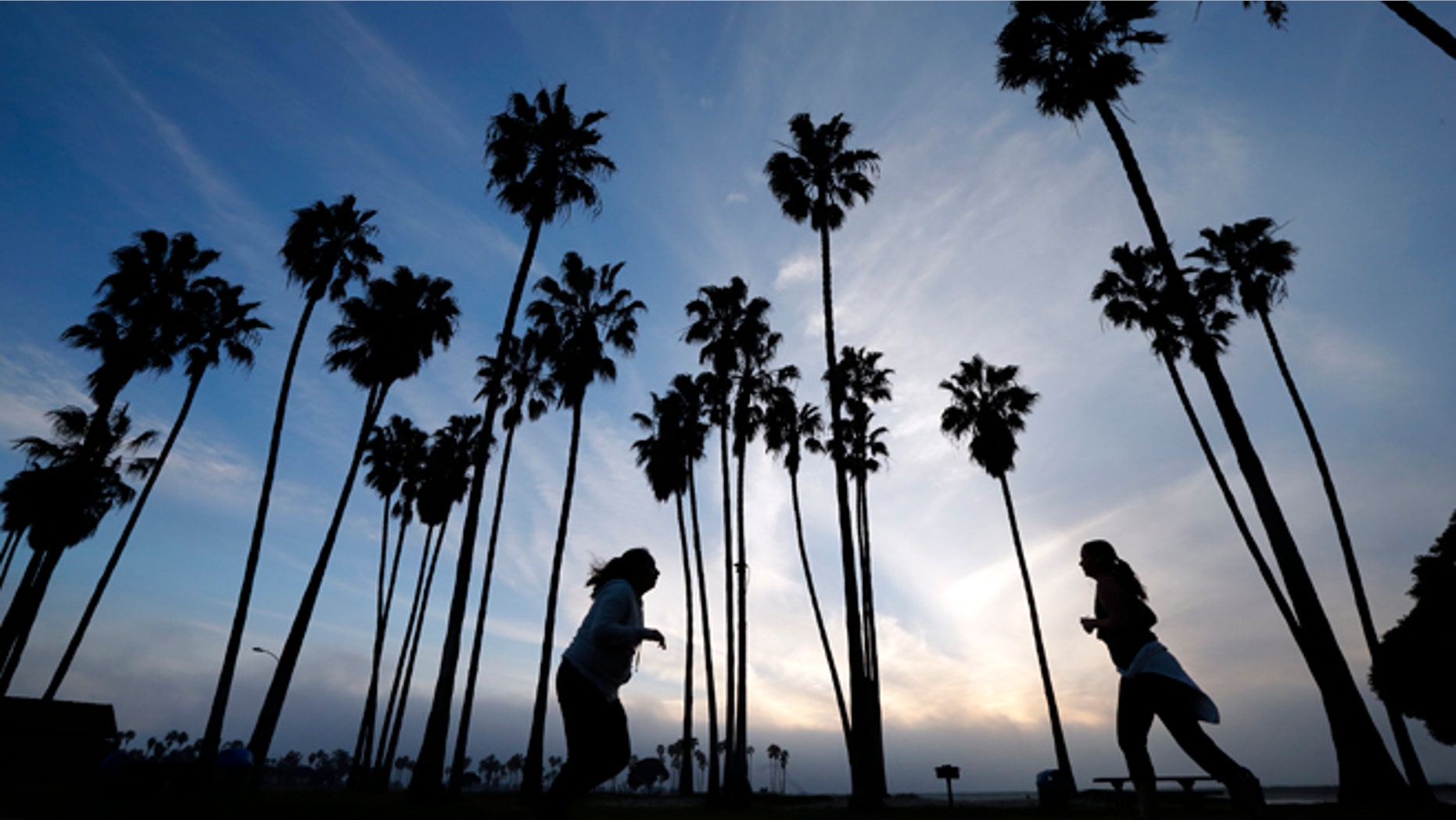 FILE - In this Feb. 23, 2016, file photo, women run as the sun sets in San Diego. Life expectancy for white women has fallen a little, according to a new government report. The dip is small - white women lost about five weeks from their predicted lifespan in 2014, compared to 2013, the Centers for Disease Control and Prevention reported Wednesday, April 20, 2016. (AP Photo/Gregory Bull, File)