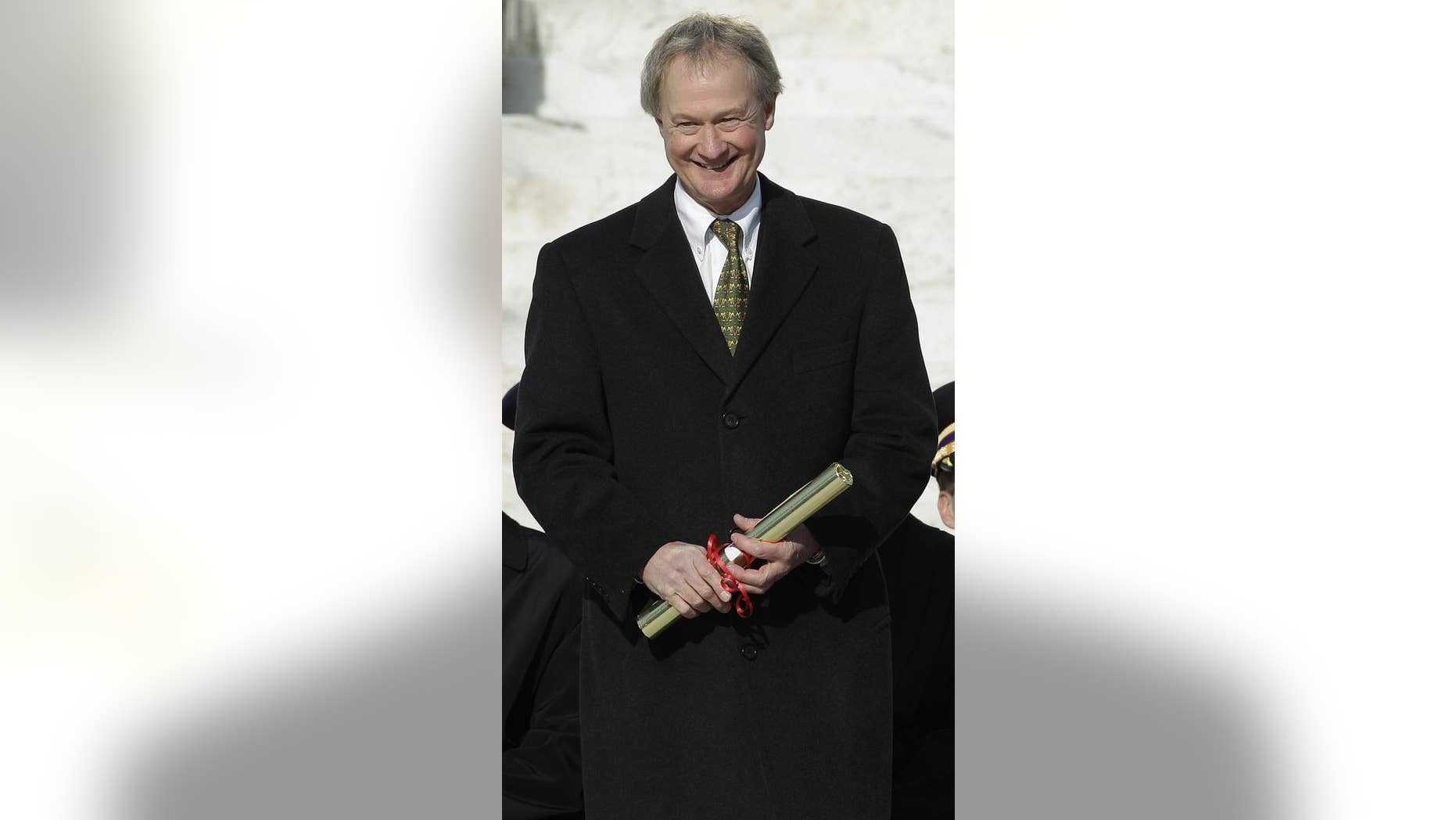 Gov. Lincoln Chafee, a former Republican U.S. senator, holds his certificate of election after taking the oath of office as Rhode Island's first independent governor on the steps of the Statehouse in Providence, R.I., Tuesday afternoon, Jan. 4, 2011. (AP Photo/Stephan Savoia)