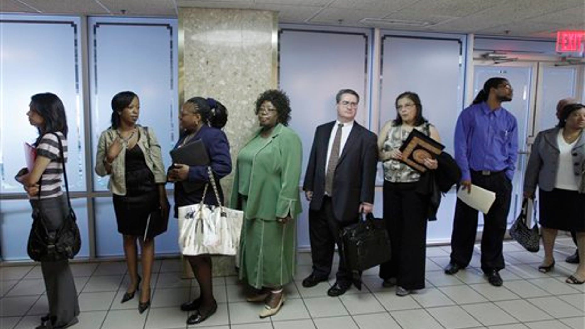 In this Aug. 4, 2011 photo, job seekers line up to register as they arrive at the Career job fair in Arlington, Va. The number of people seeking unemployment benefits decreased last week, a sign that the job market is improving slowly after a recent slump. (AP Photo/Jose Luis Magana)