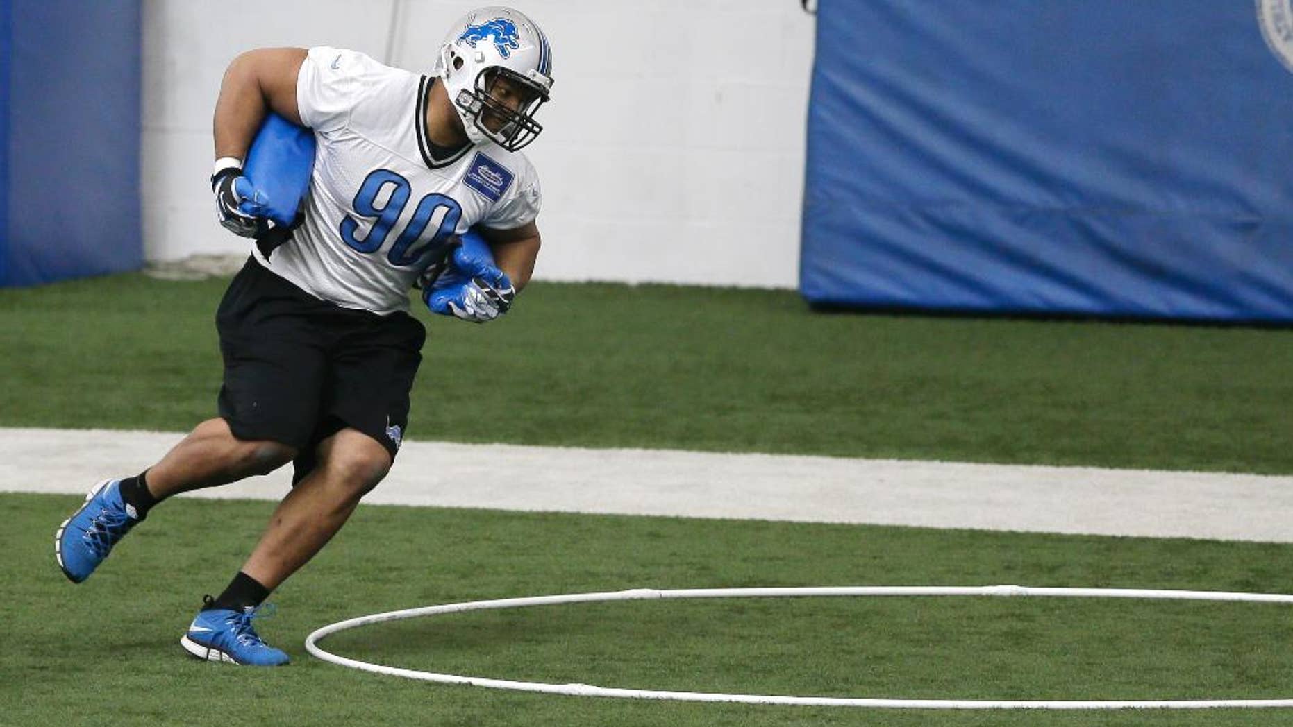 Detroit Lions defensive tackle Ndamukong Suh runs through drills during organized team activities at the Lions training camp facility in Allen Park, Mich., Wednesday, May 21, 2014. (AP Photo/Carlos Osorio)