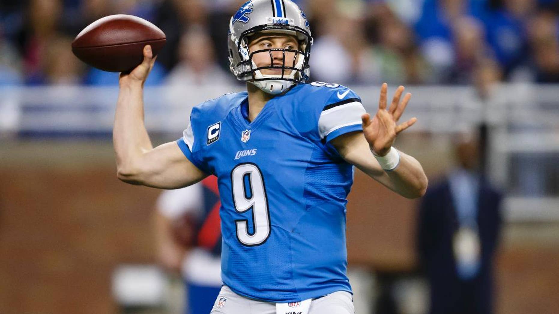 FILE - In this Dec. 22, 2013 file photo, Detroit Lions quarterback Matthew Stafford (9) passes during the second quarter of an NFL football game against the New York Giants in Detroit. With a new coaching staff and a new system to learn, Stafford enters the 2014 season under quite a bit of pressure. (AP Photo/Rick Osentoski, File)
