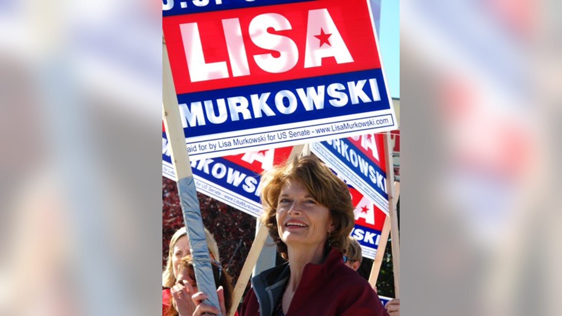 U.S. Sen. Lisa Murkowski, R-Alaska, right, joins volunteers to wave to motorists on Monday, Aug. 23, 2010, in Anchorage, Alaska. Candidates are pulling no punches in their last minute push for voters in Tuesday's primary. The greatest proof of this is in the U.S. Senate race where Sarah Palin has re emerged months after first endorsing GOP challenger Joe Miller to urge Alaskans to support him and to oust Murkowski. Murkowski's not shying away, running a new radio spot of her own, called "Truth," in which she uses audio from a talk show host's tirade against Miller to show Miller as distorting her record. (AP Photo/Mark Thiessen)