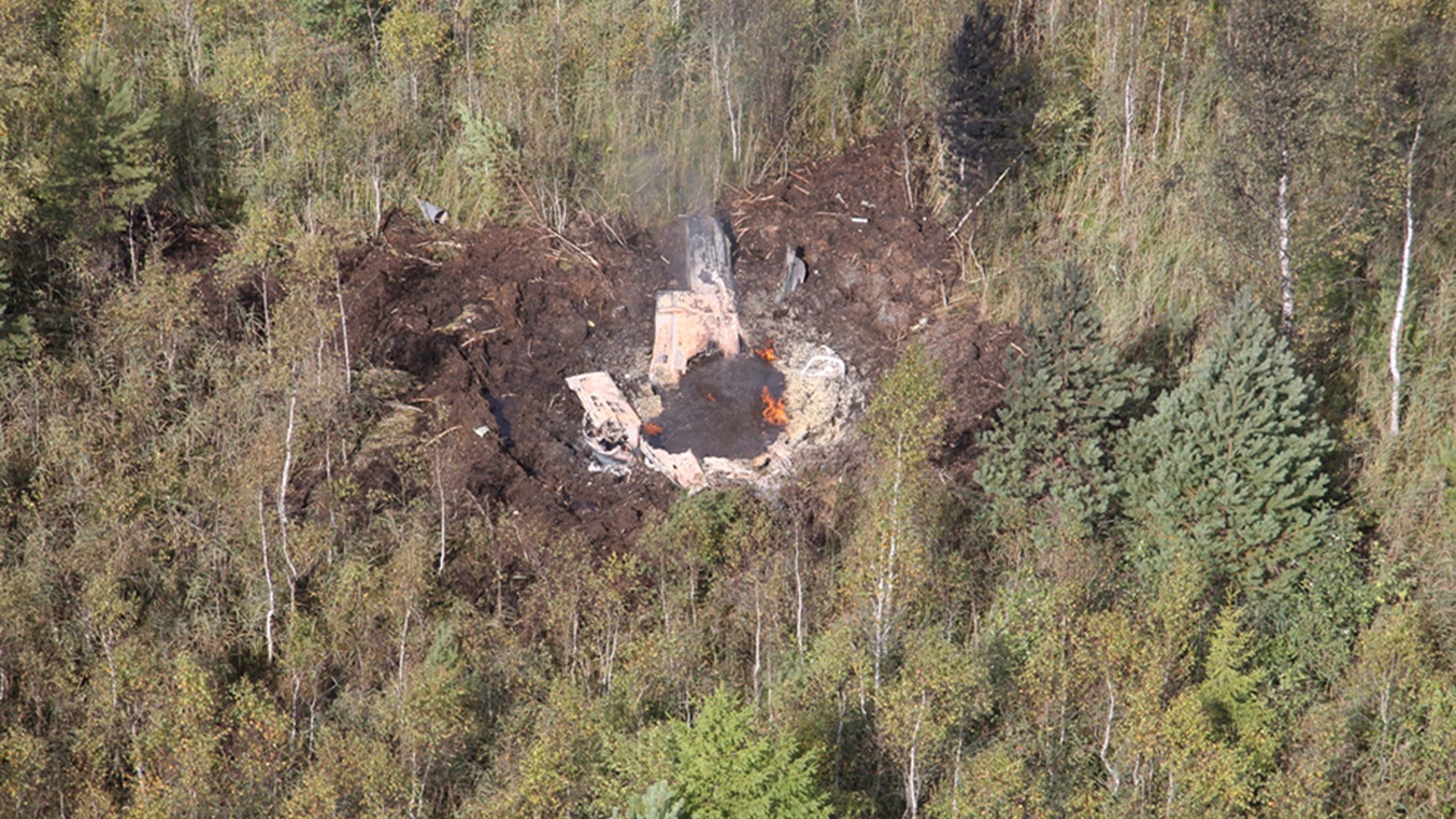 August 30: Wreckage of Czech-made Lithuanian L-39 jet is seen near the Zokniai air base in northern Lithuania.