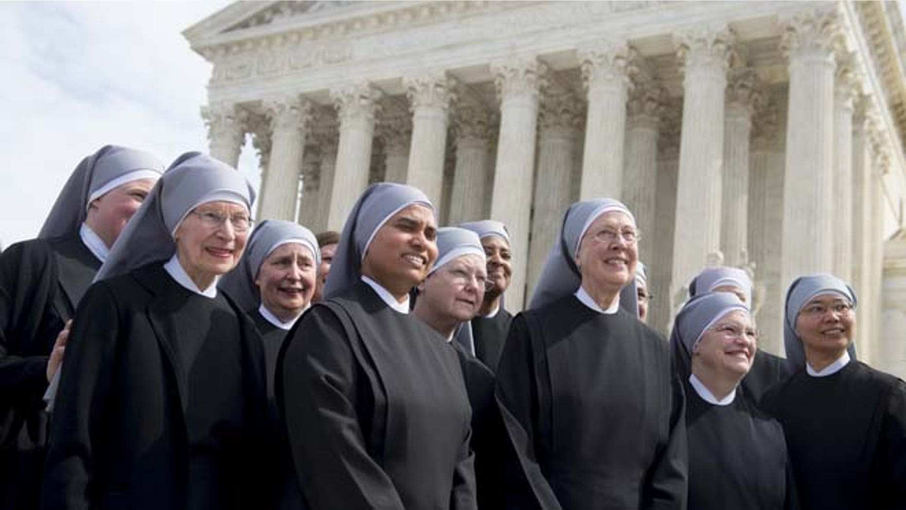 Loraine Marie Maguire (3rd R), mother provincial of the Little Sisters of the Poor, stands alongside fellow nuns following oral arguments in 7 cases dealing with religious organizations that want to ban contraceptives from their health insurance policies on religious grounds at the Supreme Court in Washington, DC, March 23, 2016. / AFP / SAUL LOEB (Photo credit should read SAUL LOEB/AFP/Getty Images)