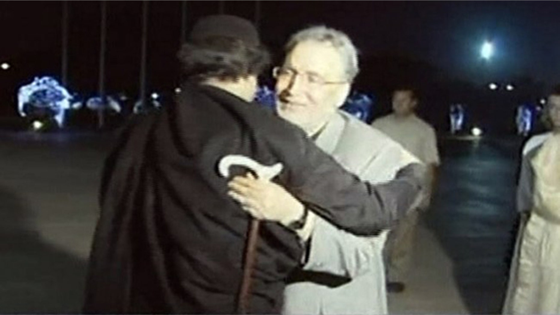 Aug. 21, 2009: In this image made from television, Abdel Baset al-Megrahi, right, who was found guilty of the 1988 Lockerbie bombing, is greeted by Libyan leader Muammar al-Qaddafi in Tripoli, Libya.