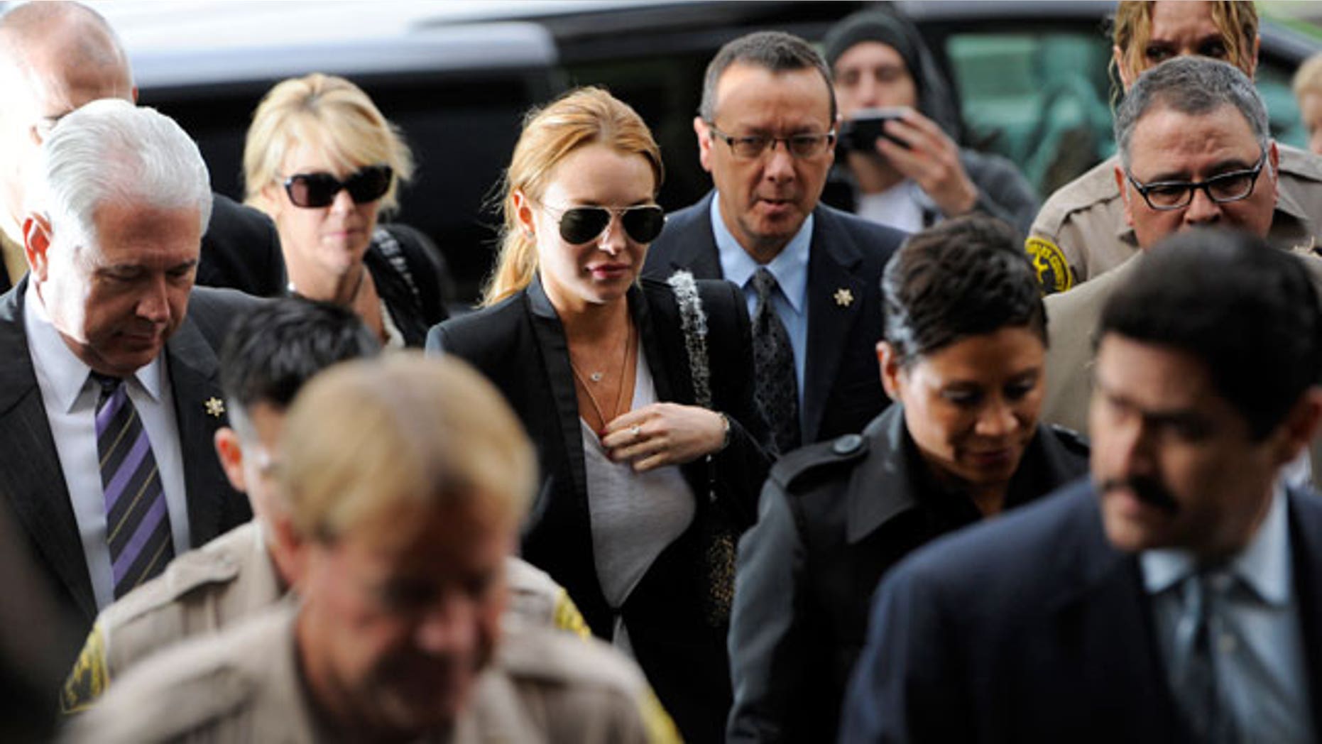 Oct. 22: Lindsay Lohan, center, arrives for a probation violation hearing at Beverly Hills Courthouse in Beverly Hills.