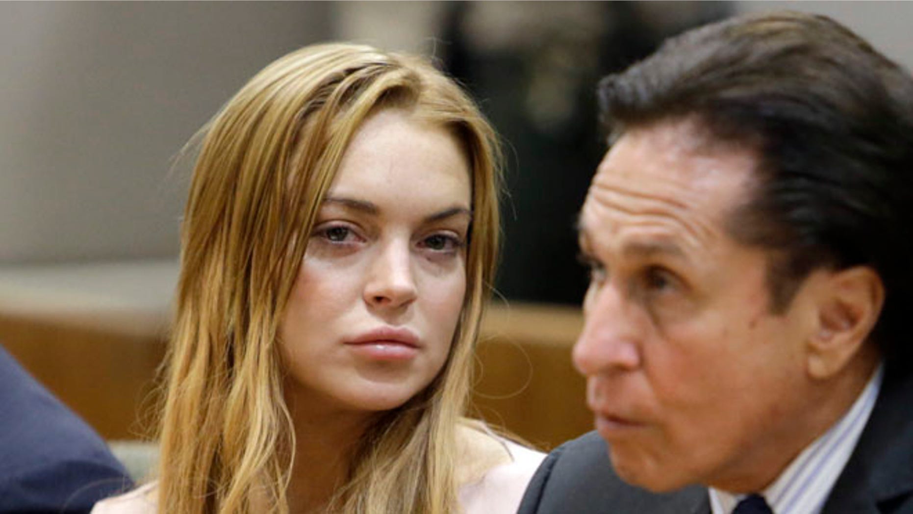 March 18, 2013: Actress Lindsay Lohan, left, and her attorney Mark Heller appear at a hearing in Los Angeles Superior Court.