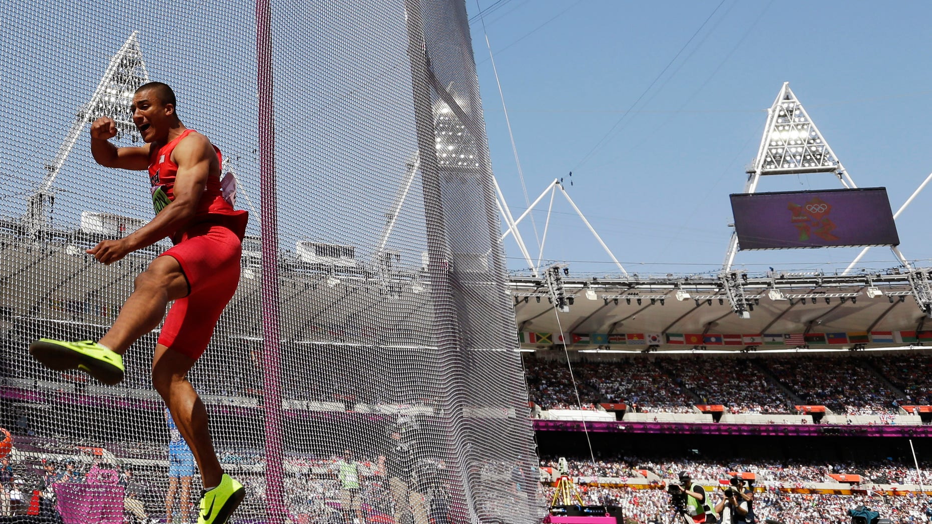 United States' Ashton Eaton takes a throw in the discus throw decathlon during the athletics in the Olympic Stadium at the 2012 Summer Olympics, London, Thursday, Aug. 9, 2012. (AP Photo/David J. Phillip)