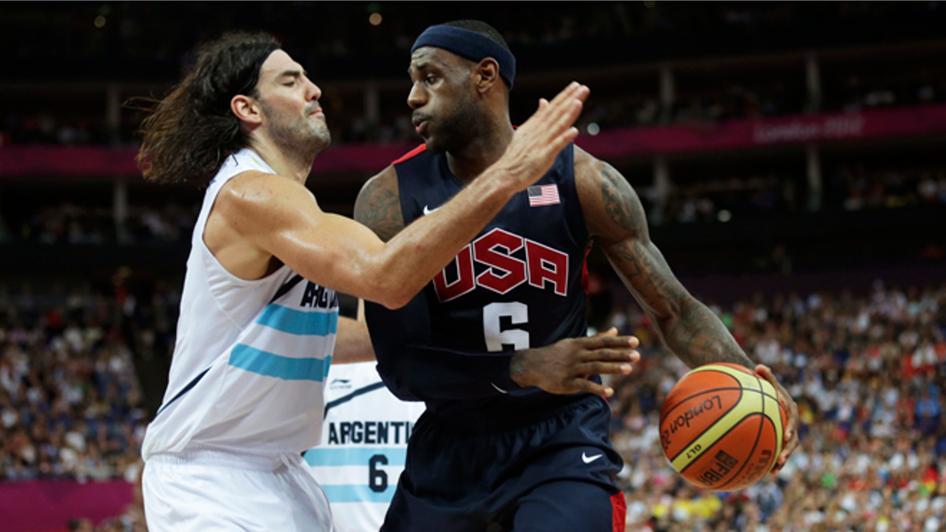 Aug. 10, 2012: United States' LeBron James, right, prepares to drive on Argentina's Luis Scola during a men's semifinals basketball game at the 2012 Summer Olympics in London.