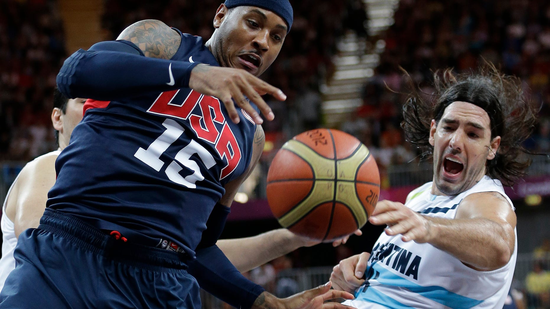 USA's Carmelo Anthony (15) and Argentina's Luis Scola, right, scramble for the ballduring a preliminary men's basketball game at the 2012 Summer Olympics, Monday, Aug. 6, 2012, in London. (AP Photo/Eric Gay)