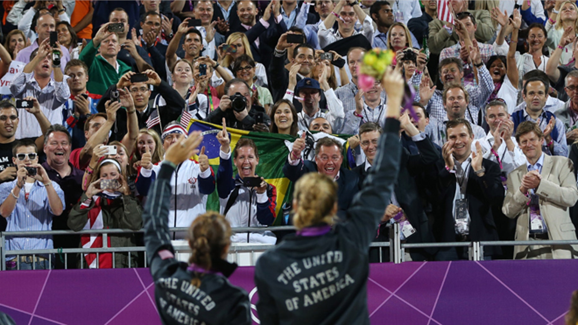 Aug. 8, 2012: Americans Missy May Treanor and Kerri Walsh Jennings acknowledge the crowd with their gold medals in beach volleyball.