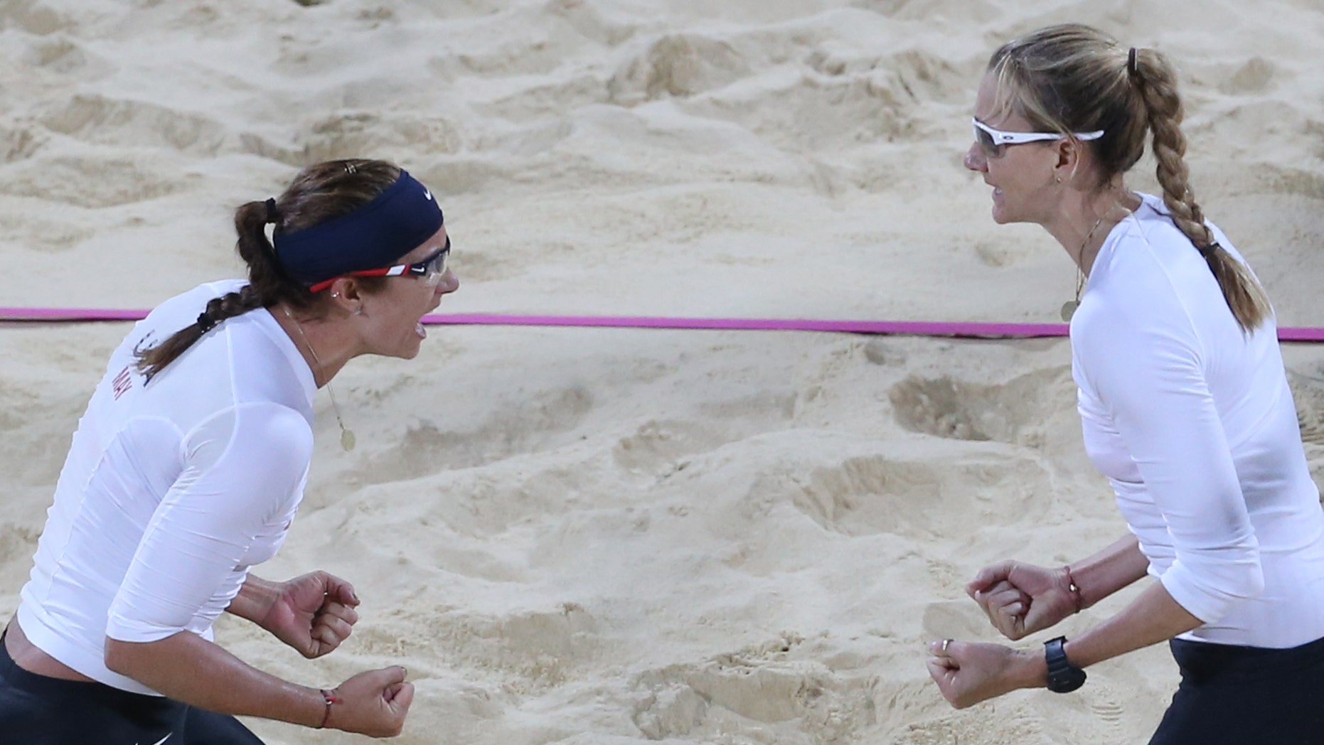 July 31, 2012: Kerri Walsh, right, and Misty May-Treanor, left, of US celebrate victory after their Beach Volleyball match against Czech Republic at the 2012 Summer Olympics in London.