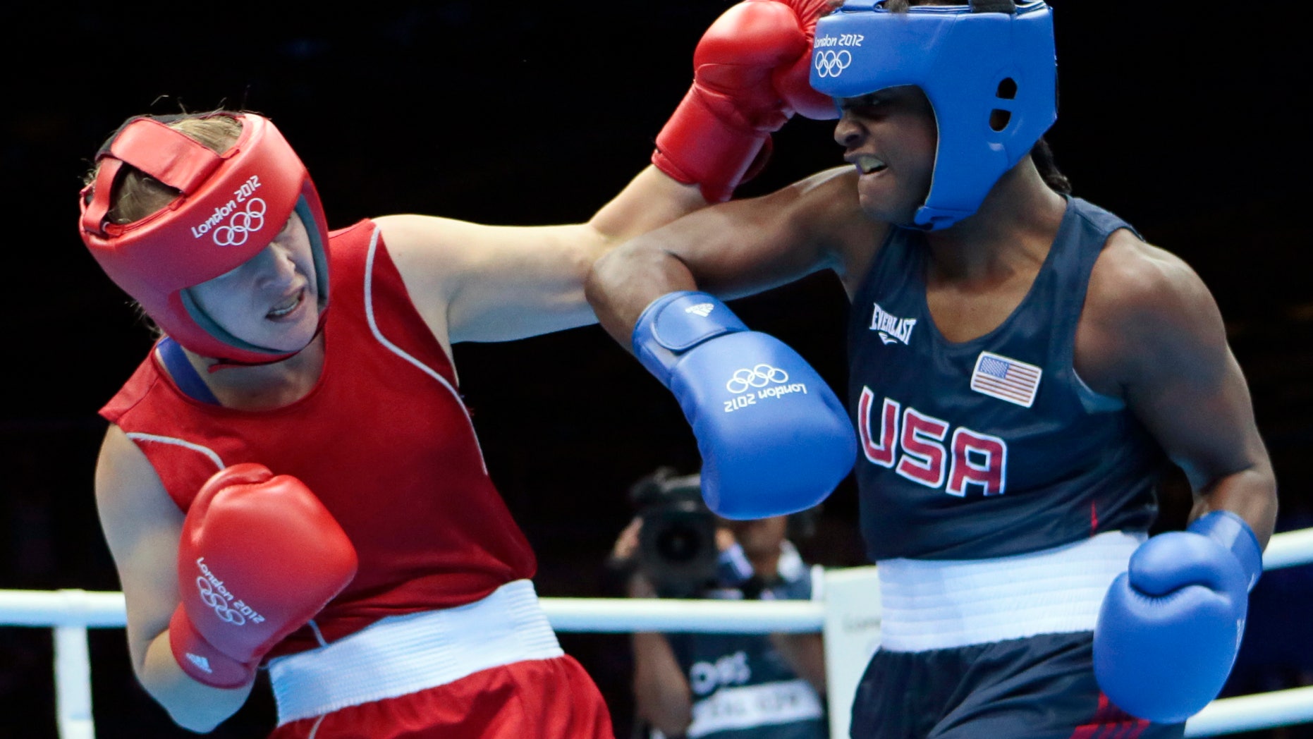 Kazakhstan's Marina Volnova, left, fights United States' Claressa Shields during their middleweight 75-kg semifinal boxing match at the 2012 Summer Olympics, Wednesday, Aug. 8, 2012, in London.(AP Photo/Ivan Sekretarev)