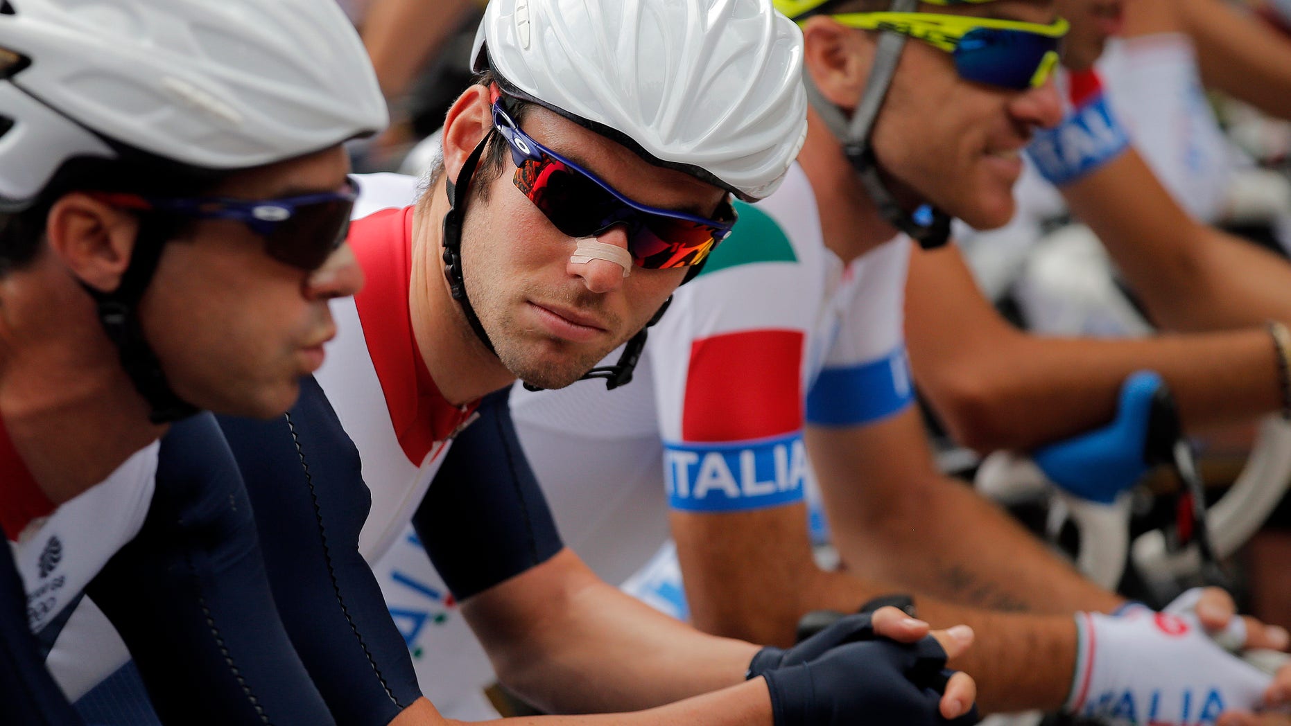 Britain's Mark Cavendish, center, prepares to start the Men's Road Cycling race at the 2012 Summer Olympics, Saturday, July 28, 2012, in London. (AP Photo/Christophe Ena)