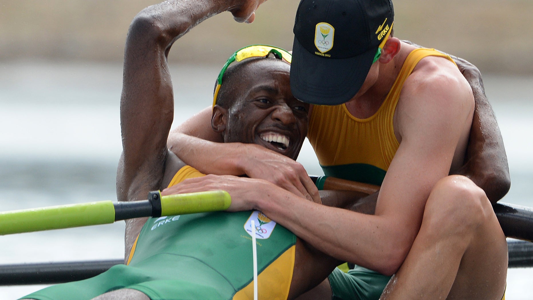 South Africa rowers Sizwe Ndlovu, left, and John Smith embrace after winning the gold medal in the men's lightweight four rowing final at the London 2012 Summer Olympics in Eton Dorney, near Windsor, England, on Thursday, Aug. 2, 2012. (AP Photo/Damien Meyer, Pool)