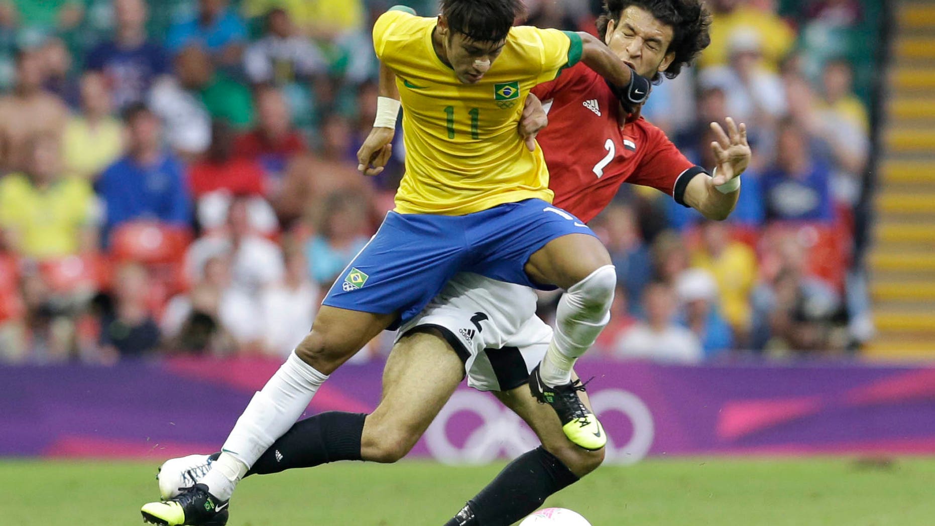 July 26, 2012: Brazil's Neymar, left, challenges for the ball with Egypt's Mahmoud Alaa Eldin during the men's group C soccer match between Brazil and Egypt, at the Millennium stadium in Cardiff, Wales, at the 2012 London Summer Olympics.