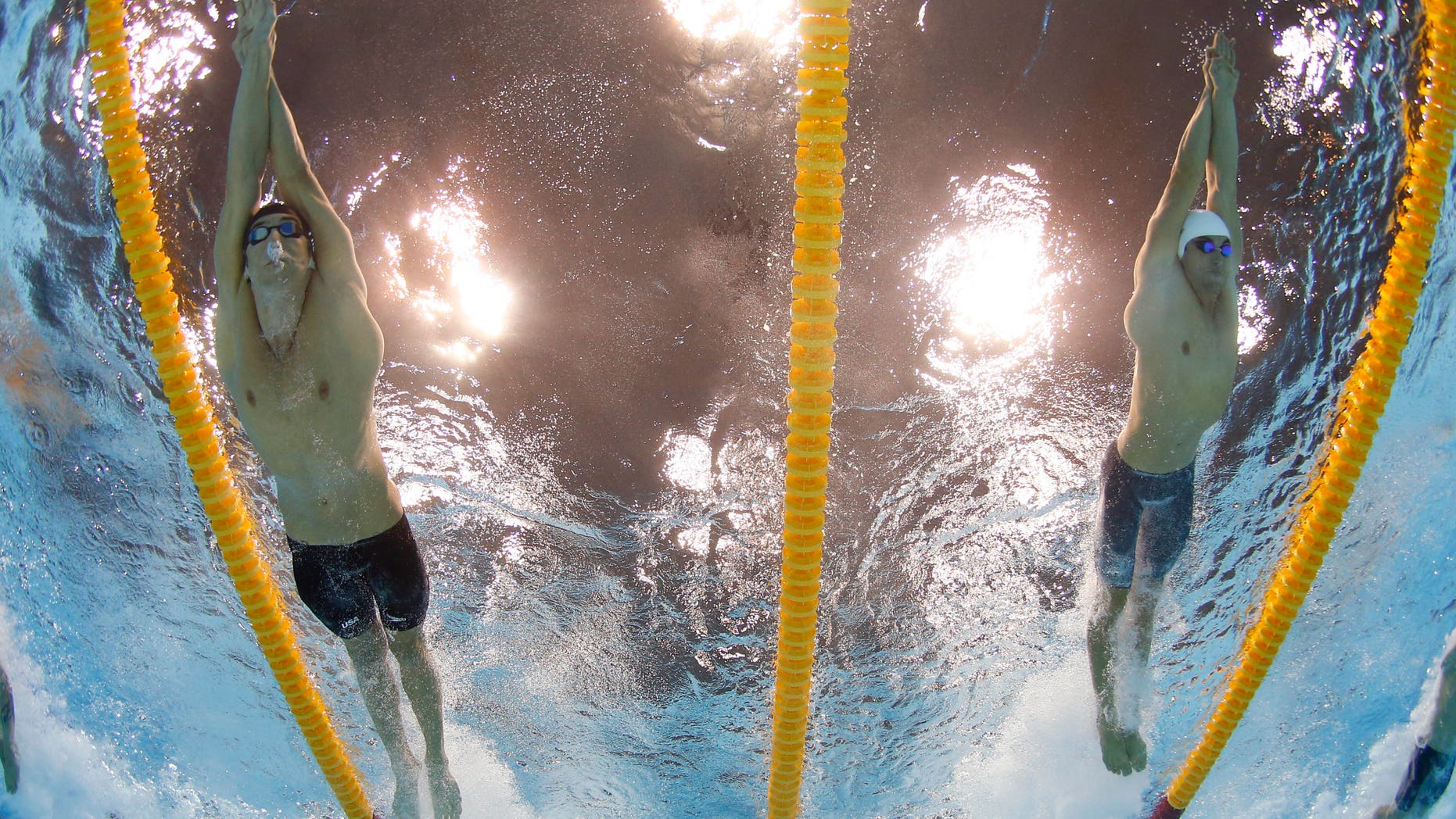 July 29, 2012: United States' Michael Phelps, left, and France's Fabien Gilot compete in the men's 4x100-meter freestyle relay final at the Aquatics Centre in the Olympic Park during the 2012 Summer Olympics in London.