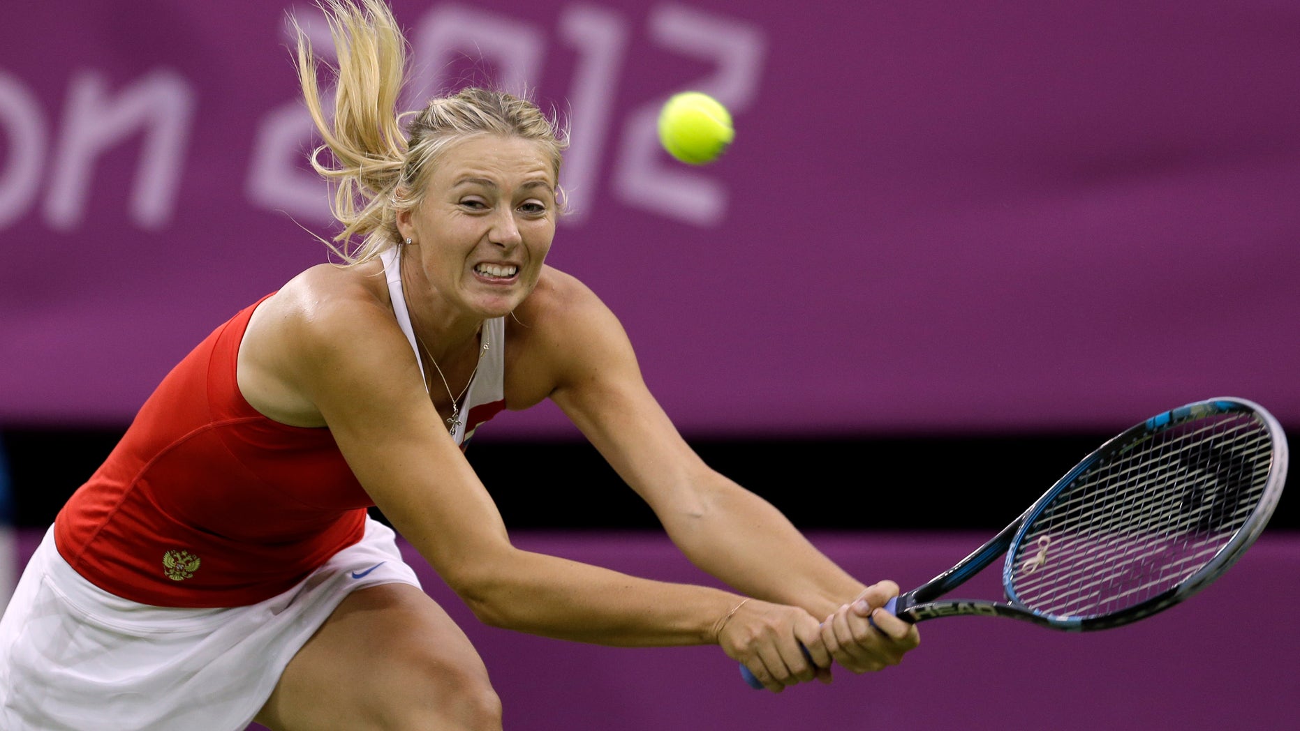 July 29, 2012: Maria Sharapova of Russia returns to Shahar Peer of Israel at the All England Lawn Tennis Club in Wimbledon, London at the 2012 Summer Olympics.