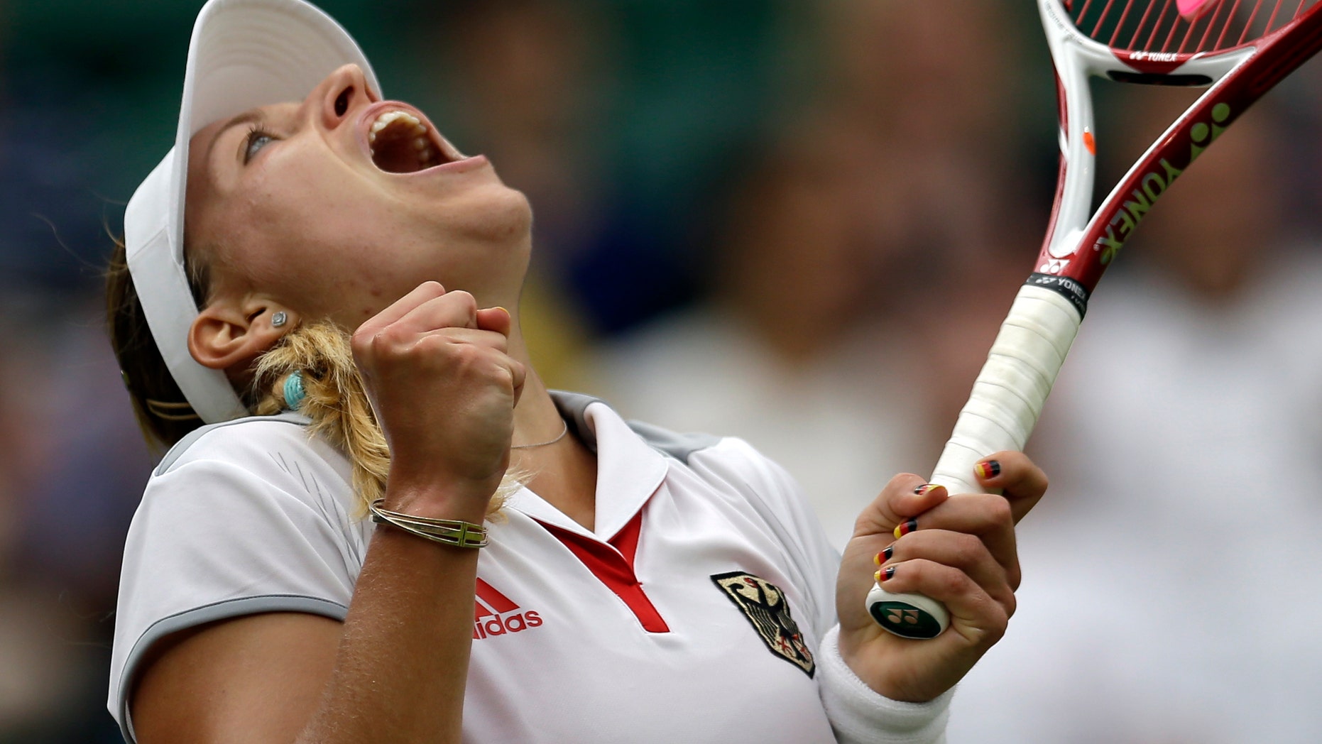 Angelique Kerber of Germany reacts during her match against Victoria Azarenka of Belarus at the All England Lawn Tennis Club in Wimbledon, London at the 2012 Summer Olympics, Thursday, Aug. 2, 2012. (AP Photo/Elise Amendola)
