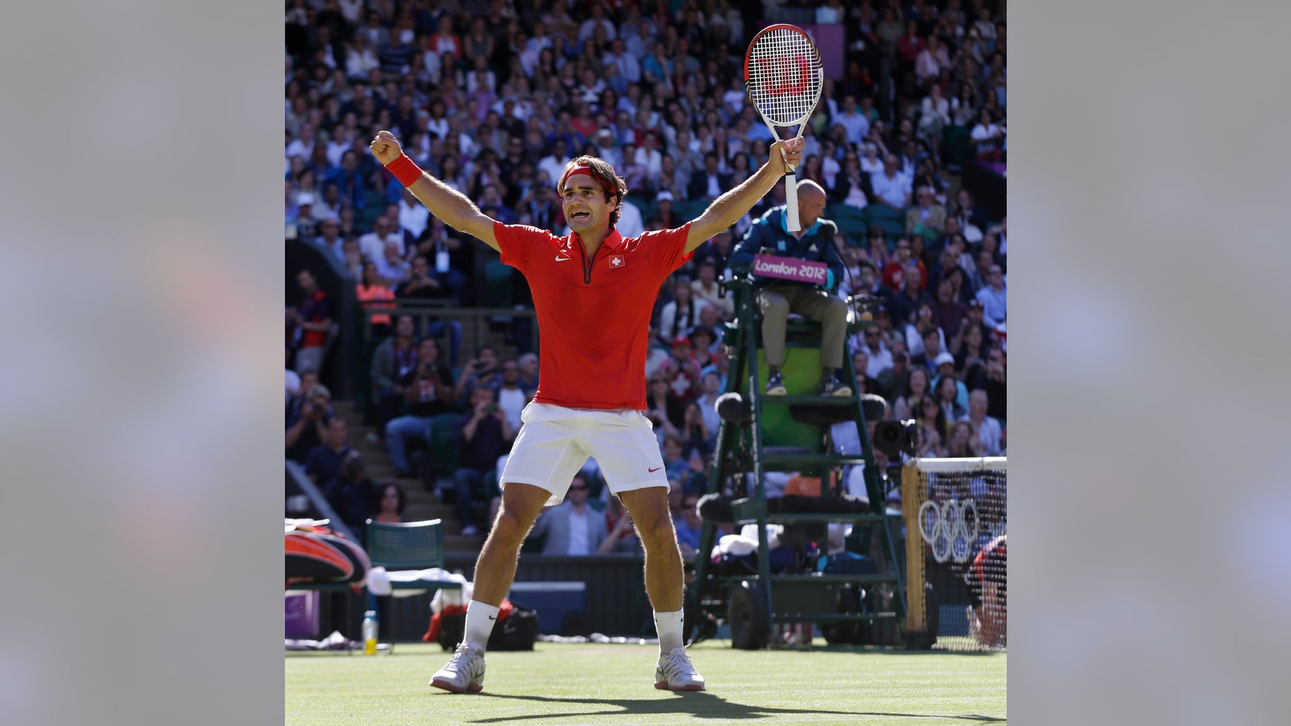 Roger Federer of Switzerland celebrates after defeating Juan Martin del Potro of Argentina at the All England Lawn Tennis Club in Wimbledon, London at the 2012 Summer Olympics, Friday, Aug. 3, 2012. (AP Photo/Elise Amendola)