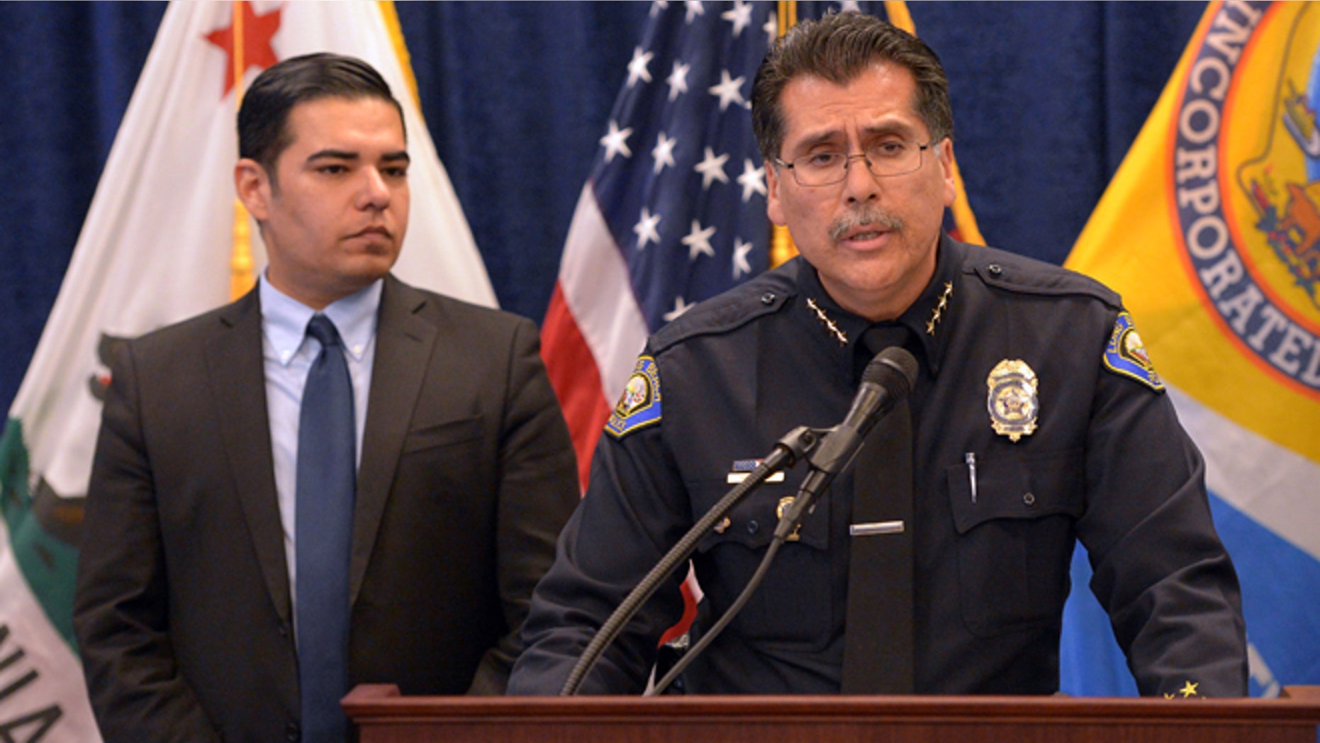 With Long Beach Mayor Robert Garcia standing next to him at left, police Chief Robert Luna pleads with the public for information in the death of a 3-week-old baby girl at a press conference in Long Beach, Calif., on Monday, Jan. 5, 2015. Eliza Delacruz was kidnapped over the weekend and found dead in a dumpster behind a shopping center in San Diego County. The baby's mother, father and uncle were all shot and wounded in the kidnapping. (AP Photo/The Daily Breeze, Scott Varley)