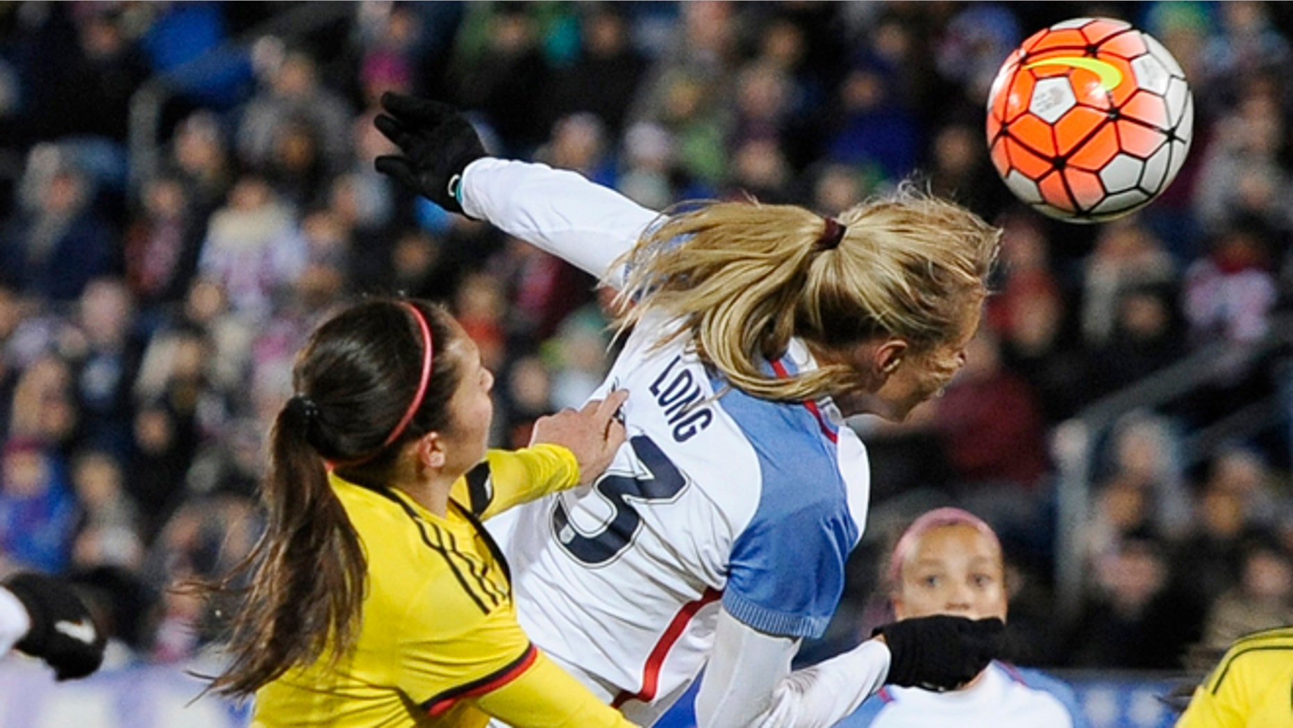 United States Allie Long, scores a goal as Colombia's Natalia Gaitan, left, defends during the first half of an international friendly soccer match Wednesday, April 6, 2016, in East Hartford, Conn.