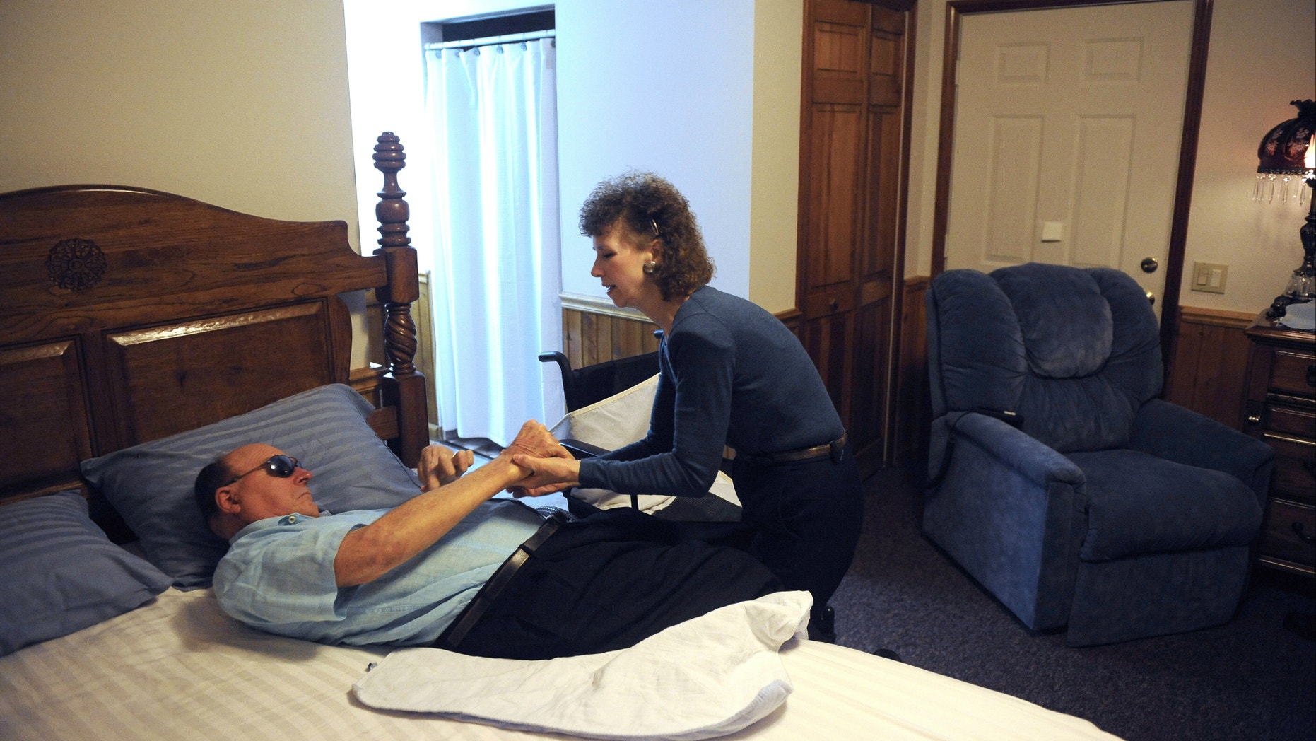 Pauline King cares for her husband Jerry King at their home in Anna, Ill. Jerry was diagnosed with Multiple Sclerosis in 1978. He can no longer go to the bathroom, bathe or dress himself without assistance from Pauline.