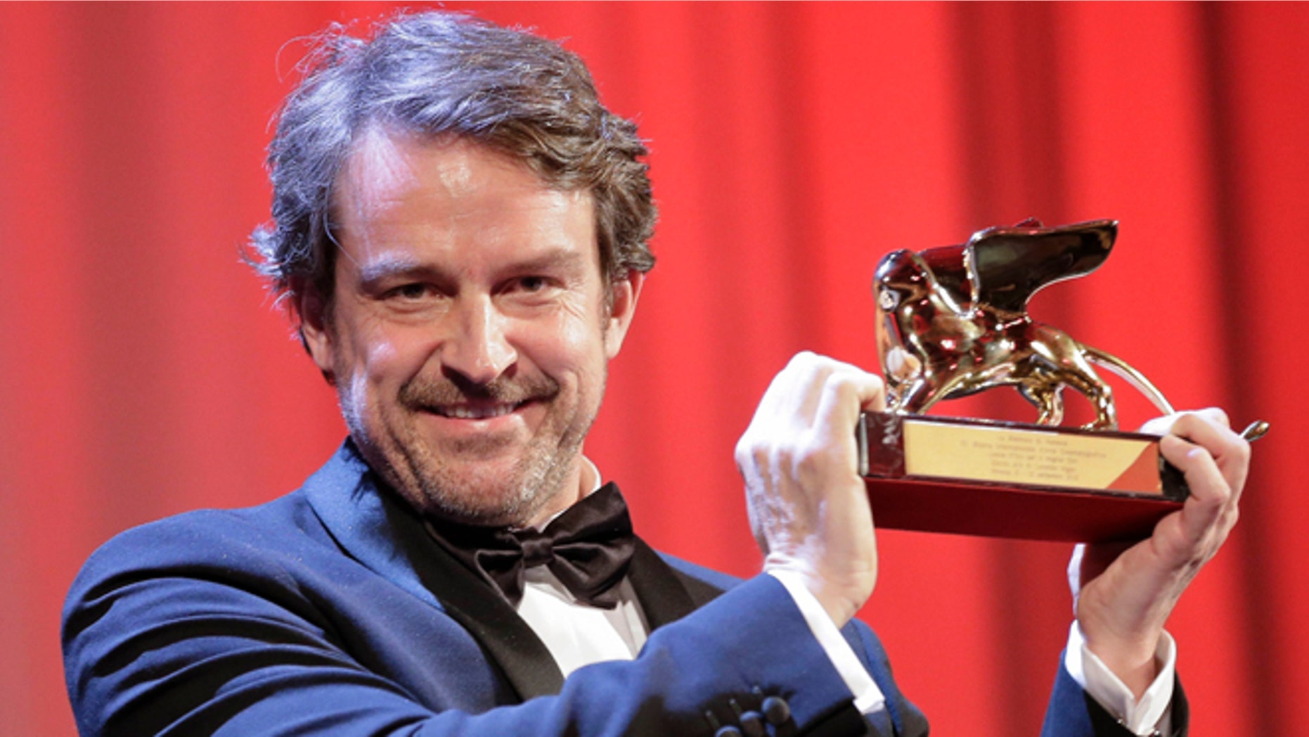 Director Lorenzo Vigas receives the Golden Lion for best film for 'Desde Alla' (From afar) during the awards ceremony of the 72nd edition of the Venice Film Festival in Venice, Italy, Saturday, Sept. 12, 2015. (AP Photo/Andrew Medichini)