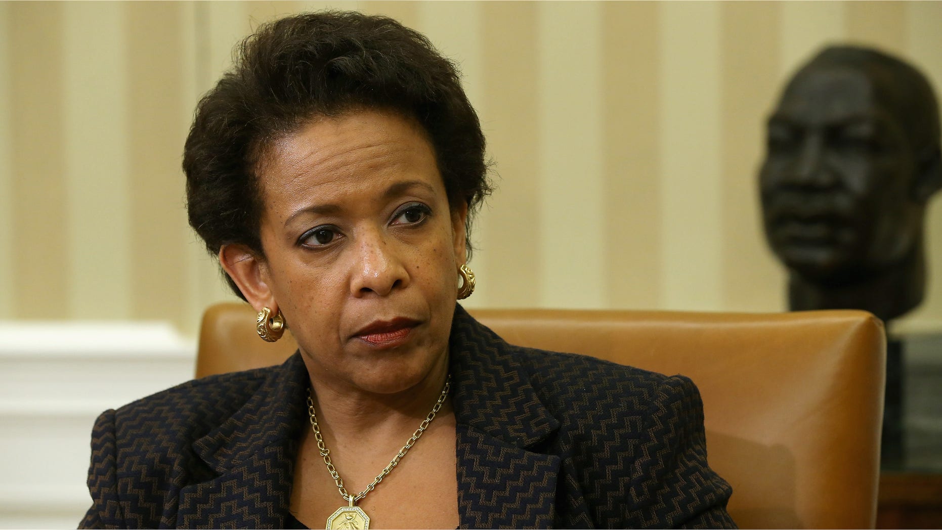 WASHINGTON, DC - MAY 29: U.S. Attorney General Loretta Lynch listens to President Barack Obama as he delivers remarks to reporters after a meeting in the Oval Office at the White House May 29, 2015 in Washington, DC. The first African-American woman to head the Justice Department, Lynch announced this week a major corruption investigation into FIFA, the world's largest soccer organizing body. (Photo by Chip Somodevilla/Getty Images)