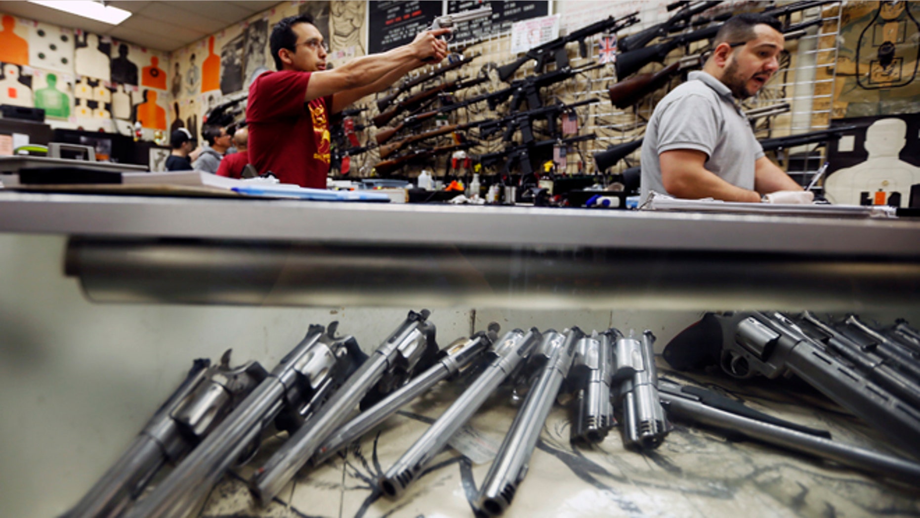 Jan. 23, 2013: Employees demonstrate gun safety to clients at the Los Angeles gun club in Los Angeles.
