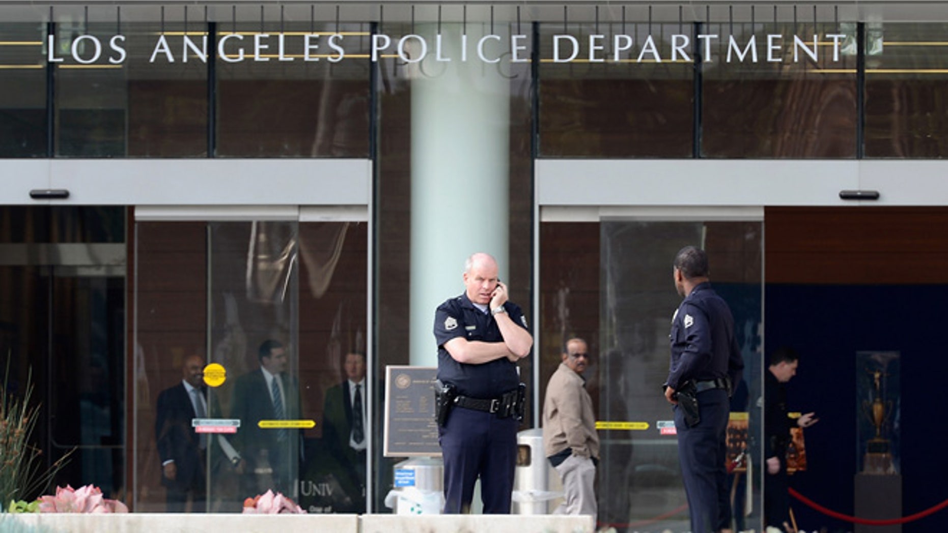 LOS ANGELES, CA - FEBRUARY 07: Los Angeles Police Department officers are deployed around the police headquarters on February 7, 2013 in Los Angeles, California. A former Los Angeles police officer Christopher Jordan Dorner, 33, who had allegedly warned he would target law enforcement, is suspected of firing on two LAPD officers and ambushing two other officers, killing one. Dorner is also a suspect in two weekend killings of Monica Quan and Keith Lawrence who were found dead in a car inside a parking structure. (Photo by Kevork Djansezian/Getty Images)
