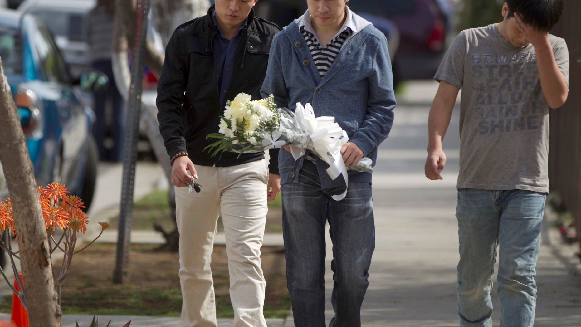 April 11: University of Southern California students bring flowers to the site of the slayings of their friends in Los Angeles.