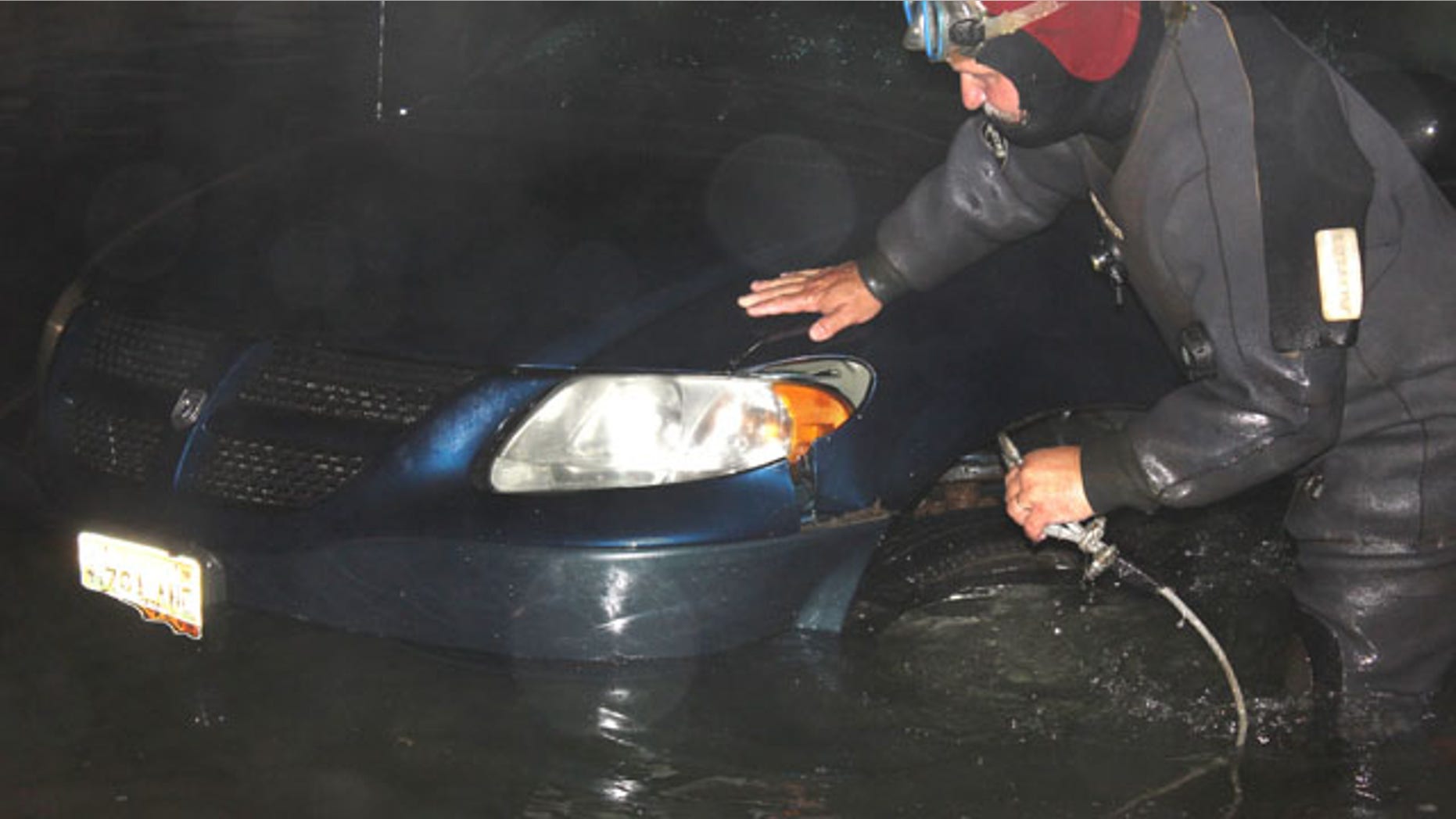 July 23, 2013: Rescue diver Travis Preston, a Jonesboro, Maine firefighter, hooks up a minivan in the water on the boat ramp at the scene of the double fatal accident in Roque Bluffs, Maine.