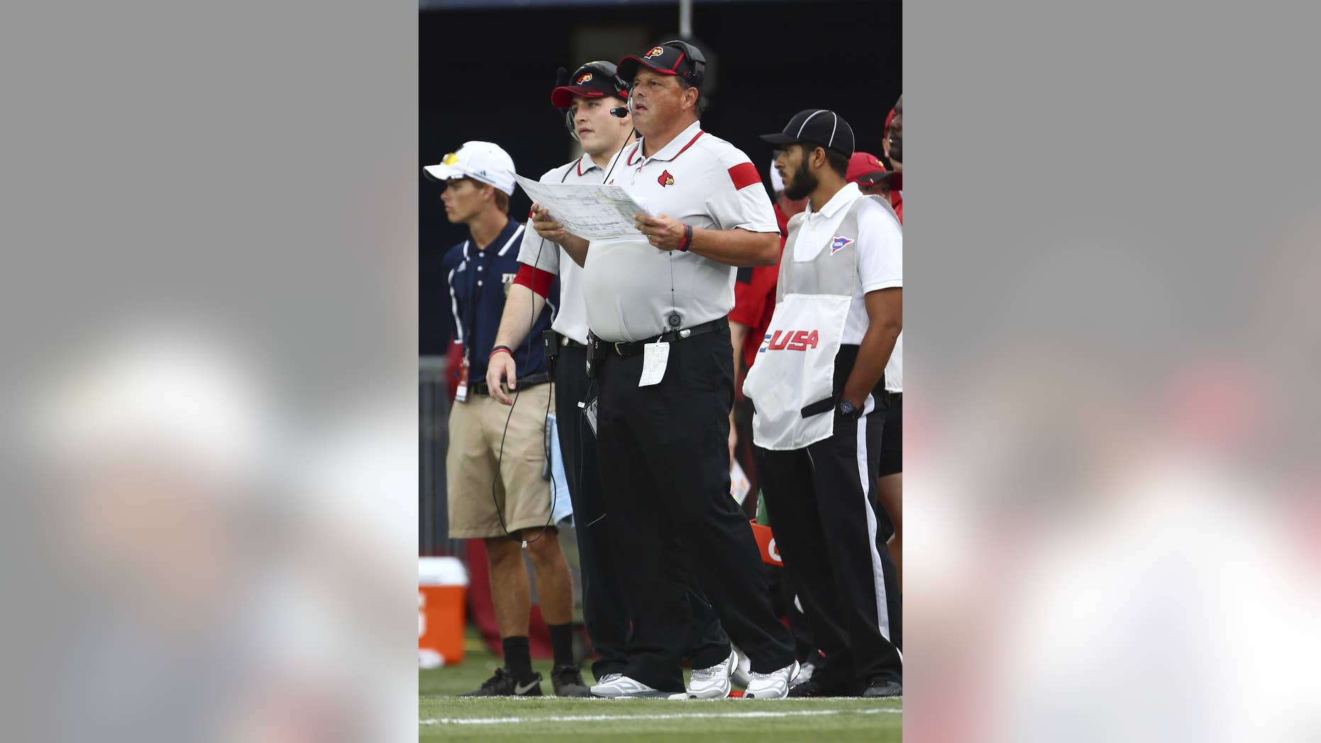 Louisville's coach Bobby Petrino watches from the sideline during the first half of an NCAA college football game against Florida International in Miami, Fla., Saturday, Sept. 20, 2014. (AP Photo/J Pat Carter)