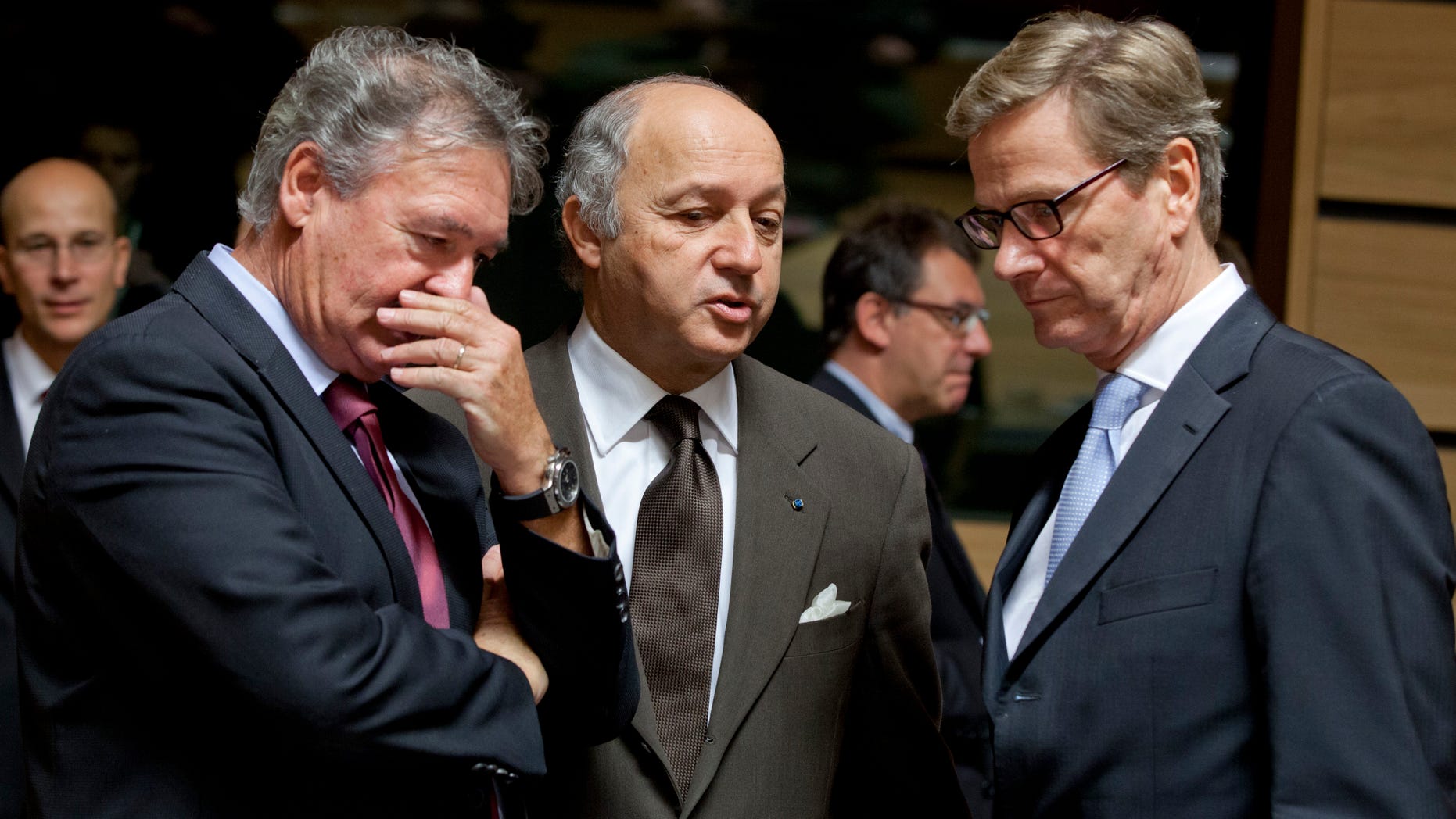 From left, Luxembourg's Foreign Minister Jean Asselborn, French Foreign Minister Laurent Fabius and German Foreign Minister Guido Westerwelle share a word during a meeting of EU Foreign Ministers in Luxembourg on Monday Oct. 15, 2012. Britain, Germany and France say they expect the European Union to approve even tougher sanctions on Iran to prevent it from developing nuclear weapons. (AP Photo/Virginia Mayo)
