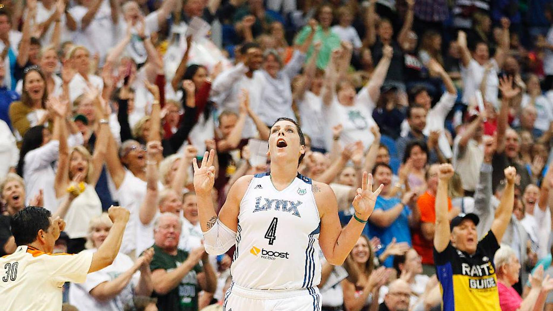 FILE - In this Sept. 4, 2013 file photo, Minnesota Lynx forward Janel McCarville (4) celebrates after hitting a three-point basket against the Los Angeles Sparks in the final second of the second quarter of a WNBA basketball game in Minneapolis. (AP Photo/Stacy Bengs, File)