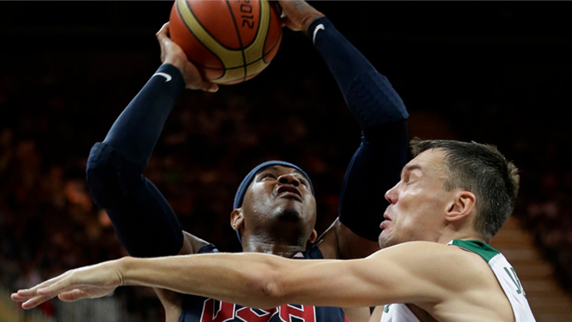Aug. 4, 2012: USA's Carmelo Anthony is defended by Lithuania's Sarunas Jasikevicius, right, during a preliminary men's basketball game at the 2012 Summer Olympics in London.