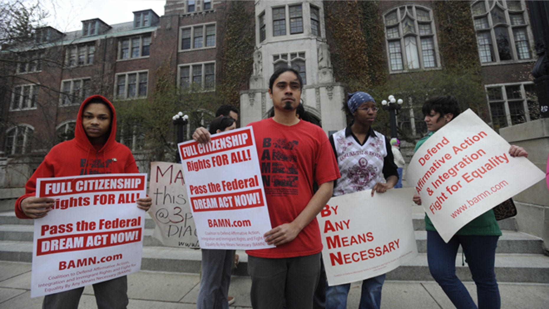Jose Alvarenga, center, BAMN (By Any Means Necessary) national organizer, and others protest the Supreme Court ruling on the campus of the University of Michigan Tuesday, April 22, 2014, in Ann Arbor, Mich. The justices ruled 6-2 that Michigan voters had the right to change their state constitution in 2006 to prohibit public colleges and universities from taking account of race in admissions decisions. (AP Photo/Detroit News, David Coates ) DETROIT FREE PRESS OUT; HUFFINGTON POST OUT, MANDATORY CREDIT