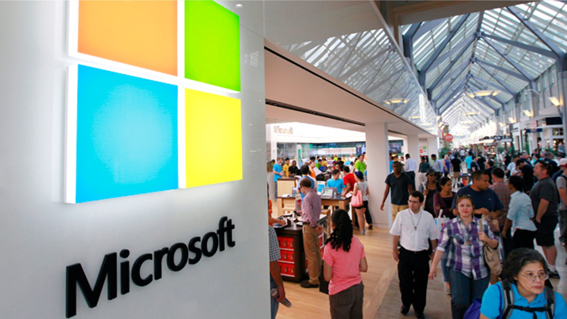 FILE photo: - In this Thursday, Aug. 23, 2012 file photo, the Microsoft Corp. logo, left, is seen on an exterior wall of a new Microsoft store inside the Prudential Center mall, in Boston. (AP Photo/Steven Senne, File)