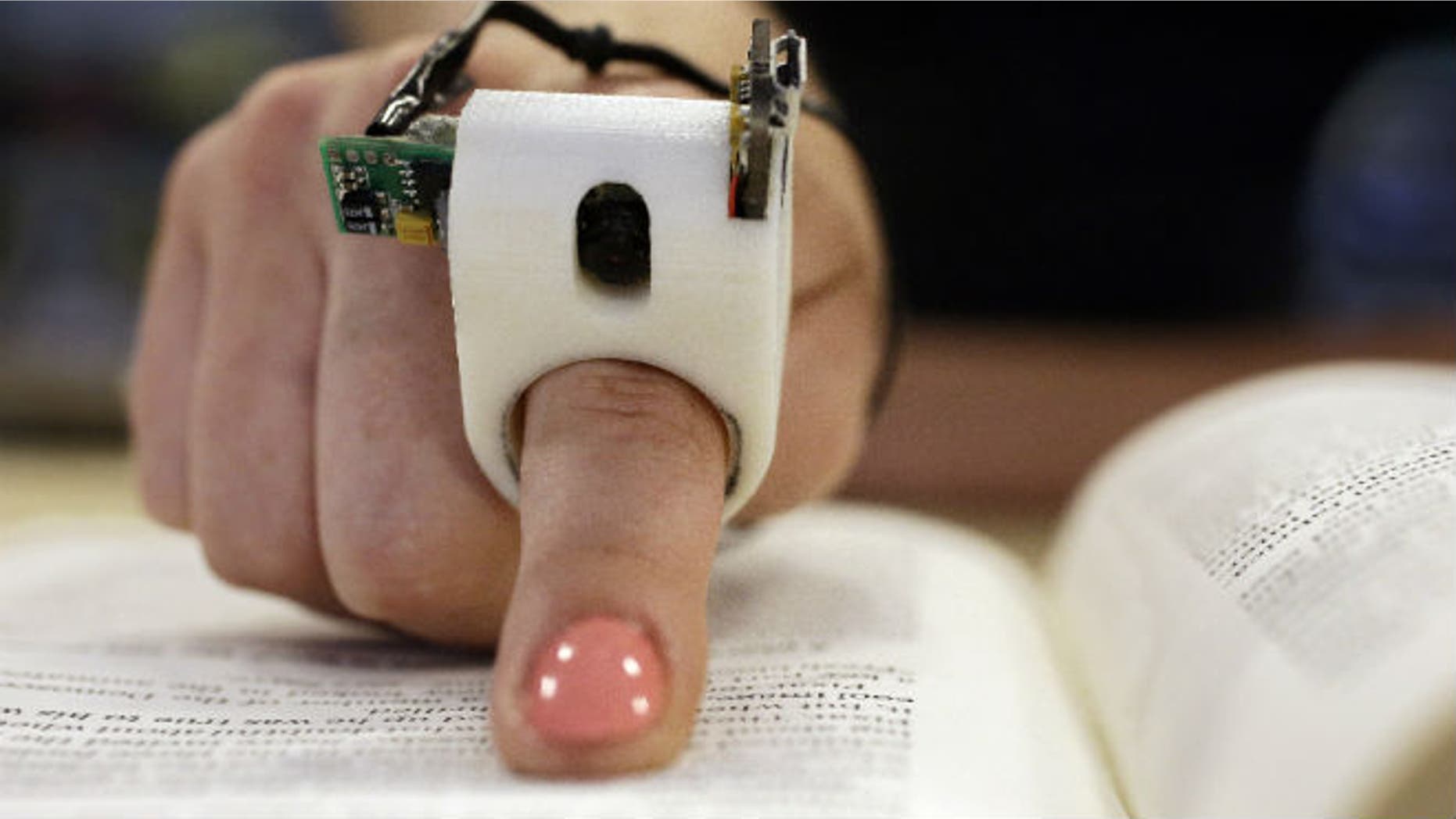 A model wears a FingerReader ring at the Massachusetts Institute of Technology's Media Lab in Cambridge, Mass. (AP Photo Stephan Savoia)